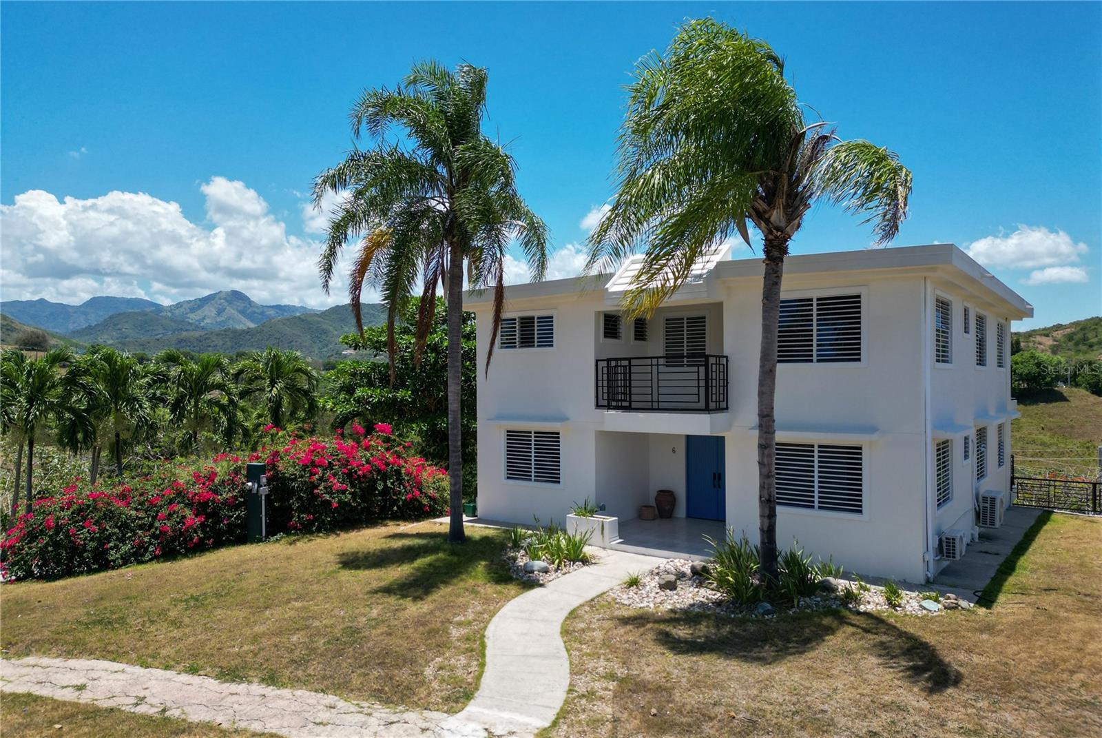Nestled within the exclusive gated community of Haciendas Yaucanas in Yauco, this custom-built residence offers breathtaking mountain views, spectacular sunsets, and a peaceful setting surrounded by nature. Situated on an expansive 2,030-square-meter lot, this three-level home features 2,543 square feet of living space thoughtfully designed for comfort, functionality, and family living.
The main level features a welcoming living room, dining area, kitchen, one bedroom, and one full bathroom. The second level offers five additional rooms, including a dedicated gym space. The spacious primary suite includes a walk-in closet and a private en-suite bathroom, while an additional full bathroom serves the remaining bedrooms. In total, the property offers 6 bedrooms and 3 full bathrooms.

The lower level features a large covered garage and basement area with space for up to 4 vehicles, providing ample storage and flexibility. Multiple balconies extend along the rear of the home on every level, creating the perfect space to enjoy the stunning mountain views, cool breezes, and unforgettable sunsets that make this area so special.

Additional highlights include solar panels that help supplement the home's energy consumption, ample outdoor space, and the privacy and security of a gated community. Whether enjoying your morning coffee overlooking the mountains or gathering with family and friends to watch the sunset, this home offers a truly unique lifestyle.

A rare opportunity to own a spacious mountain-view residence in one of Yauco's most desirable gated communities, combining privacy, natural beauty, and generous living space.