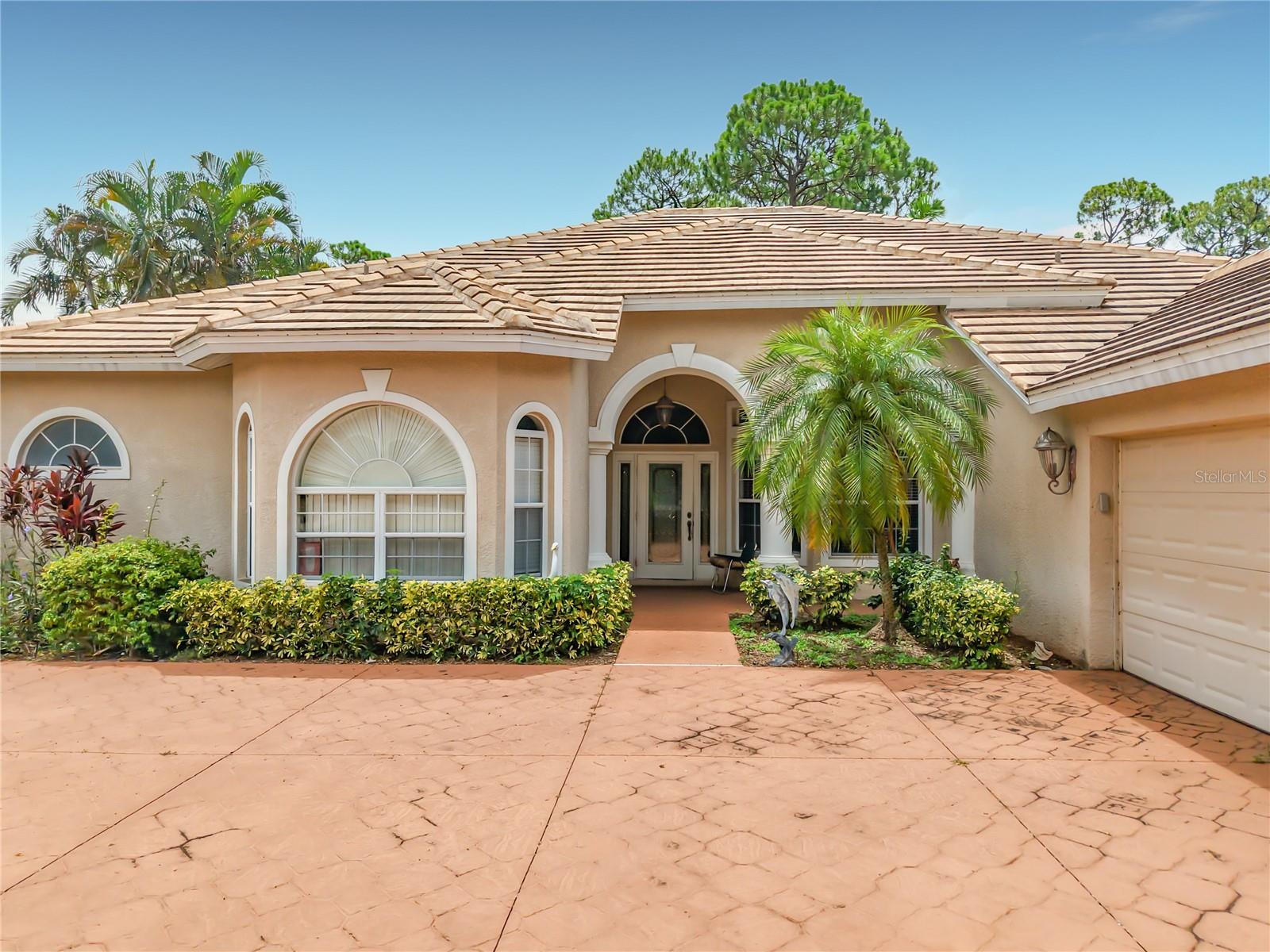 Welcome to this beautifully maintained golf course community home where comfort, space, and peaceful views come together. Perfectly suited for cash buyers as well as buyers utilizing financing, this residence showcases a spacious, thoughtfully designed floor plan with soaring ceilings, abundant natural light, and inviting living spaces throughout. Step inside to a grand foyer that opens to an elegant formal living and dining area, creating a welcoming first impression for both everyday living and entertaining. The expansive layout flows seamlessly into the main living areas, while large windows and sliding glass doors provide tranquil views of the lush golf course and mature landscaping beyond. The generously sized kitchen provides ample cabinet and counter space, a center island, breakfast bar, and an open connection to the family room, making it ideal for gathering with family and friends. The split-bedroom floor plan provides privacy, with spacious bedrooms featuring high ceilings and plenty of natural light. The primary suite creates a relaxing retreat with generous proportions and an ensuite bath designed for everyday comfort. Outside, enjoy the beautifully landscaped yard and picturesque golf course backdrop, providing a peaceful setting to relax, entertain, or simply enjoy Florida's year-round sunshine. The mature trees and established landscaping enhance both privacy and curb appeal. Conveniently located near shopping, dining, medical facilities, parks, golf, and everyday conveniences, this home provides an exceptional opportunity for buyers seeking space, comfort, and a desirable location. Whether you're searching for a primary residence, seasonal getaway, or long-term investment, this well-maintained home is ready for its next owner. Schedule your private showing today and experience everything this wonderful property has to provide!
