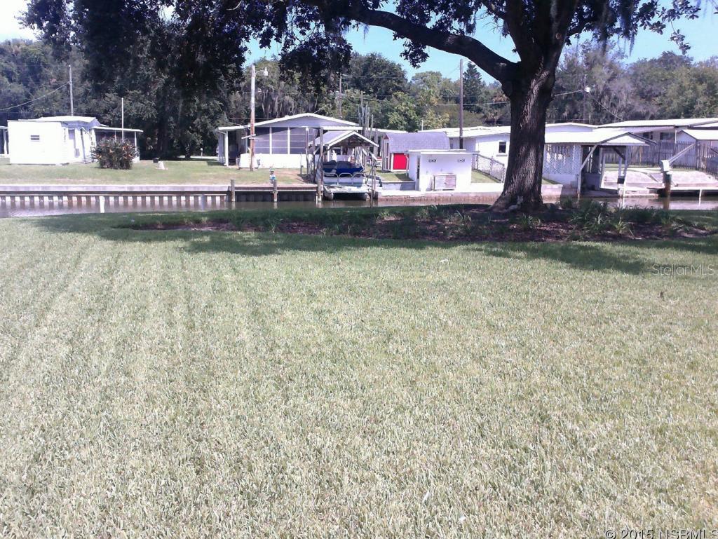 This nice grassy 50' X 190' lot is located on one of the deep water canals near world renowned Mosquito Lagoon.  Located in an area where large new homes are built.  Adjoining home and lot may also be purchased.