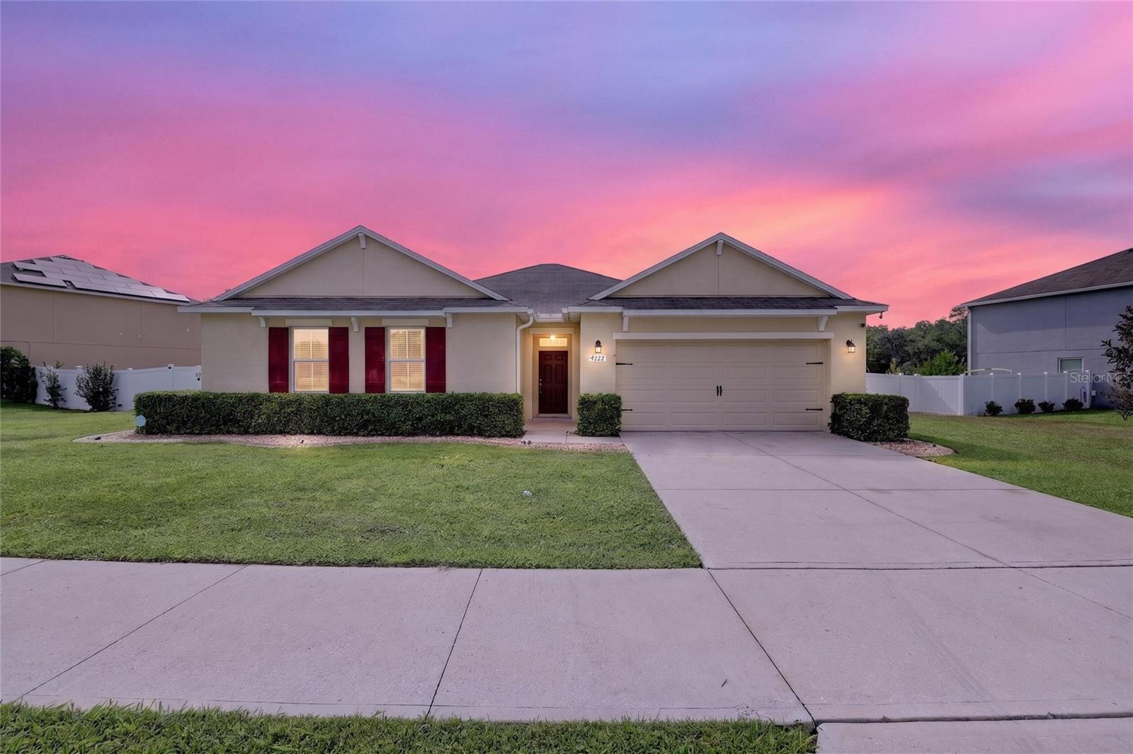 Welcome to this move-in ready 4-bedroom, 2-bath beauty in Oak Hill Plantation, where stunning curb appeal is just the beginning! Step inside to fresh neutral paint throughout and lovely, easy-care luxury vinyl plank flooring. The gorgeous open kitchen features a brand-new stainless refrigerator and range, a breakfast bar, and a dining area — all flowing into a large great room that looks out over the covered, pavered patio with TV. And then... the backyard. The sparkling 2024 pool with beautiful custom details, two pergolas offering shaded spaces to relax and entertain, and automatic evening lighting create a true resort feel in your own backyard. Backing up to a retention area, this property offers the peaceful feel of being away from it all. The spacious primary suite is joined by three nicely sized guest bedrooms, all with ceiling fans, and two well-appointed baths. A single gate on one side and a double gate on the other — with hidden space alongside the home for a trailer or boat — add flexibility you'll love. This one truly has it all — don't miss it!