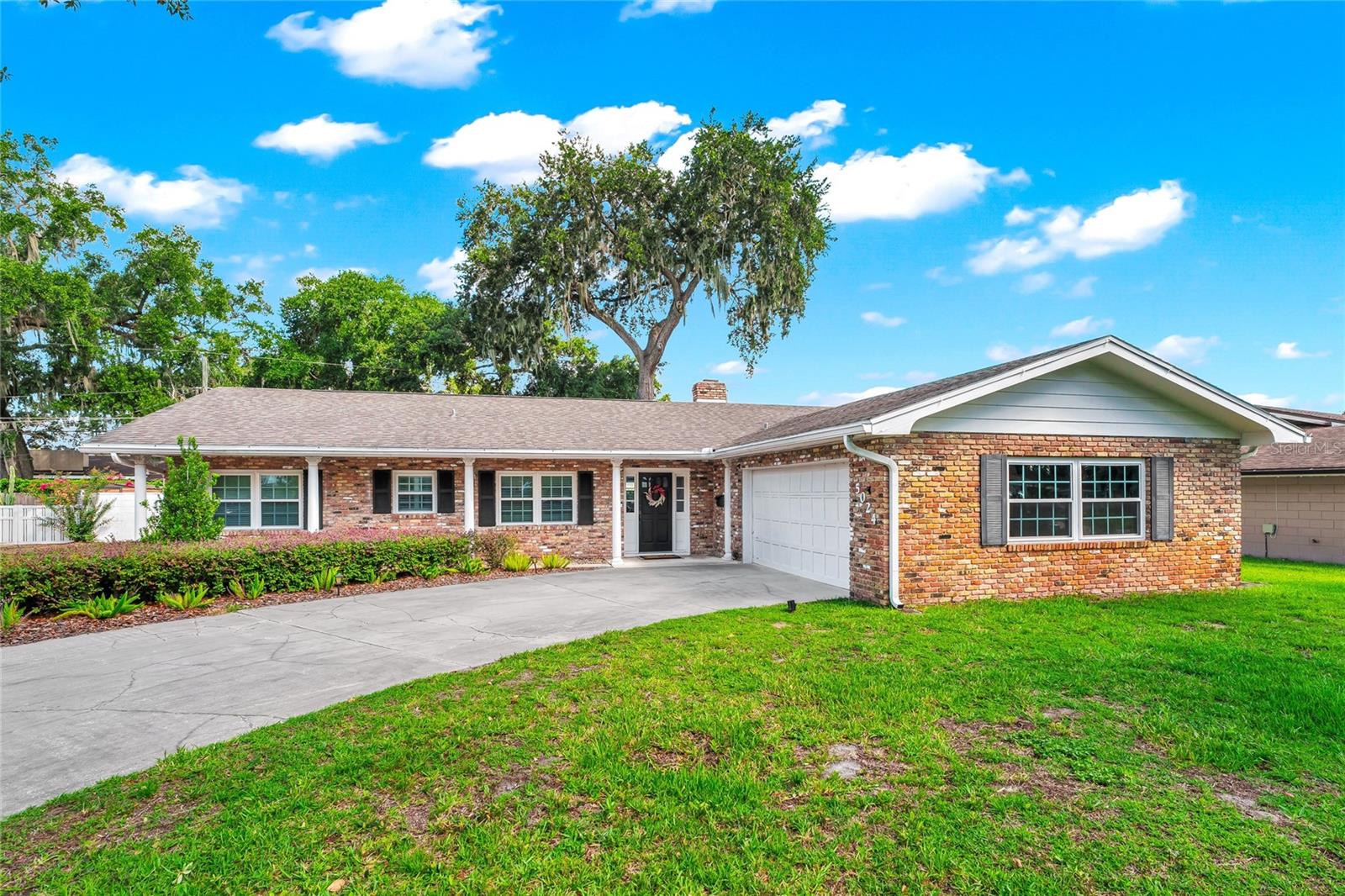 Move-in ready with the big-ticket items already done! Welcome to this 4-bedroom, 2.5-bath pool home in sought-after Lake Conway Estates, less than a quarter mile from the community boat ramp, lakefront park, and playground (optional low-fee HOA). This classic single-story brick ranch sits on over a quarter acre framed by a majestic moss-draped oak and a curved drive with excellent curb appeal.
Inside, a wood-burning brick fireplace with rustic mantel anchors the family room, which flows into the dining area and a renovated kitchen featuring granite countertops, stacked stone backsplash, crisp white cabinetry, stainless appliances, and a breakfast bar. A second living room offers a full wall of custom built-in bookshelves and storage — perfect as a library, media room, or playroom. The primary suite features an updated en-suite bath and French doors opening to the covered lanai.
The backyard is pure Florida living: a sparkling in-ground pool with brick paver deck and removable child-safety fence, a covered lanai with ceiling fan and café lighting for year-round outdoor entertaining, and a large, private fenced yard with lush lawn and mature landscaping. A paver side drive adds room for a boat or trailer — the Conway Chain of Lakes is just down the street.
Big-ticket items are done: whole-house repipe (2026), new A/C (2024), new windows (2021), new water heater (2023), updated pool equipment (2024), 2018 roof. A dedicated office nook in the garage — with its own mini-split A/C — makes working from home easy without sacrificing garage space. Minutes to Orlando International Airport, downtown Orlando, and major highways. Schedule your private showing today!