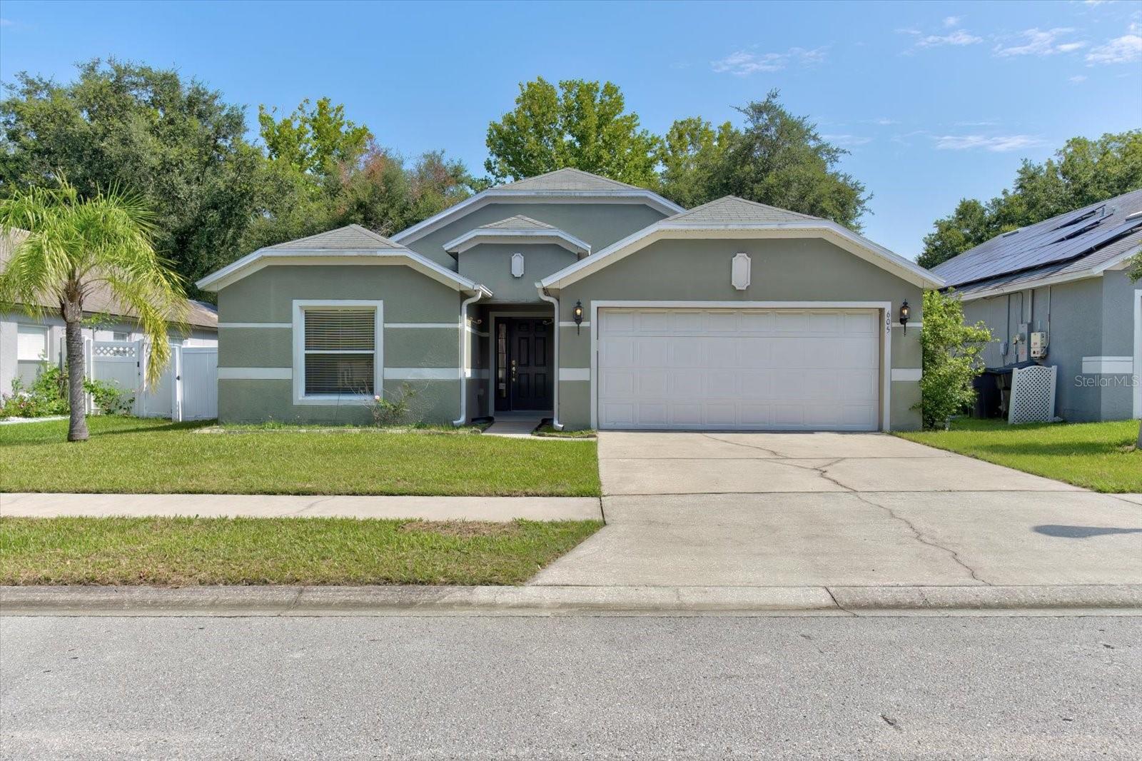 Virtually Staged. Welcome to this Move-In-Ready, 4-bedroom, 2-bath home in the desirable Blue Springs Villas community, offering nearly 1,787 square feet of thoughtfully designed living space. Situated on a quiet street, this home features a split-bedroom floor plan, vaulted ceilings, and an open-concept layout that is perfect for both everyday living and entertaining.The spacious kitchen is the heart of the home, showcasing stainless steel appliances, abundant cabinetry, a breakfast nook, and a separate dining area for larger gatherings. The private primary suite offers a relaxing retreat with a double vanity, soaking tub, and separate shower, while the versatile fourth bedroom is ideal as a home office, guest room, or playroom. Enjoy Florida living in the fully fenced backyard featuring an extended patio, perfect for entertaining, pets, or simply relaxing outdoors. Additional highlights include a laminate and tile flooring, landscape irrigation system, attic storage, and a 2-car garage. Blue Springs Villas offers a community playground and is conveniently located just minutes from Blue Spring State Park, Stetson University, historic Downtown DeLand, shopping, dining, medical facilities, and I-4, providing an easy commute to Orlando and Daytona Beach, with Florida's beautiful beaches approximately 30 minutes away. Don't miss this opportunity to own a well-maintained home in one of Orange City's most convenient locations—schedule your private showing today!