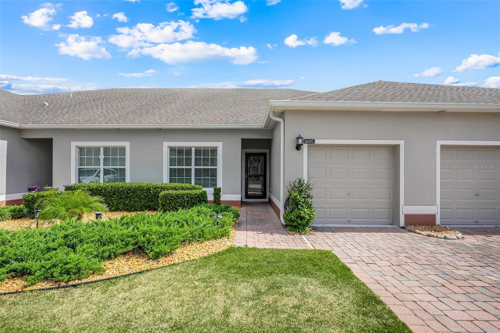 Welcome to 3641 Solana Cir, Unit C—a warm and inviting villa located in the highly desirable Heritage Hills 55+ community in Clermont. Built in 2015, this well-maintained St. Lucia model offers 2 bedrooms, 2 bathrooms, a one-car garage with an overhead storage rack, a versatile flex room, and 1,374 square feet of thoughtfully designed living space. Sliding glass doors open to a beautiful extended screened-in lanai, providing the perfect spot to relax, read, or entertain guests—an upgraded feature that many villas simply don’t offer. Even better, this home sits in the Kalamata subdivision, just steps away from the impressive 19,000 sq. ft. clubhouse, making it incredibly convenient to enjoy all the community amenities.

The freshly painted exterior and included storm door enhance the home’s curb appeal, while the split bedroom layout ensures privacy for both the primary suite and the guest suite. The guest bedroom includes its own ensuite bathroom, which also connects to the foyer for easy access when hosting visitors. A flexible bonus room adds even more usability—ideal as a home office, formal dining room, hobby space, or extra storage. Tile flooring flows throughout the main living areas, and ceiling fans are installed in the living room and both bedrooms.

The kitchen overlooks the main living area and features a breakfast bar with granite countertops, stainless steel appliances (GE stove and microwave, Bosch dishwasher with pull-out utensil tray, and a Samsung French-door refrigerator are all included), pendant lighting, two closet pantries, and an open layout perfect for entertaining. The laundry room includes a Whirlpool top-load washer and a GE dryer.

The spacious primary bedroom includes an oversized walk-in closet, while the remodeled primary bathroom offers dual sinks with upgraded faucets, a large walk-in shower with handrail, updated flooring, and a quartz countertop—creating a clean, modern retreat. This well-designed floor plan delivers low-maintenance living in one of Clermont’s premier active adult communities.

Heritage Hills is celebrated for its peaceful atmosphere, gated entry, beautifully maintained grounds, and resort-style amenities. Residents enjoy a clubhouse, fitness center, resort-style pool and spa, tennis and pickleball courts, bocce ball, shuffleboard, walking trails, and a full calendar of social events and activities. The HOA fee also includes exterior painting on a scheduled cycle, roof replacement, lawn maintenance, high-speed internet, and reclaimed irrigation water.

The location is another standout feature. Heritage Hills is conveniently close to Publix, restaurants, shopping, medical facilities, major roadways, Downtown Clermont, scenic lakes, golf courses, Lake Louisa State Park, the Florida Citrus Tower, Lakeridge Winery, and many other local attractions. Orlando, Walt Disney World, and Orlando International Airport are all within easy reach, offering the perfect blend of convenience and tranquility.

Heritage Hills offers the ideal combination of comfort, recreation, and low-maintenance Florida living. Schedule your private showing today and discover why so many residents are proud to call Heritage Hills home.