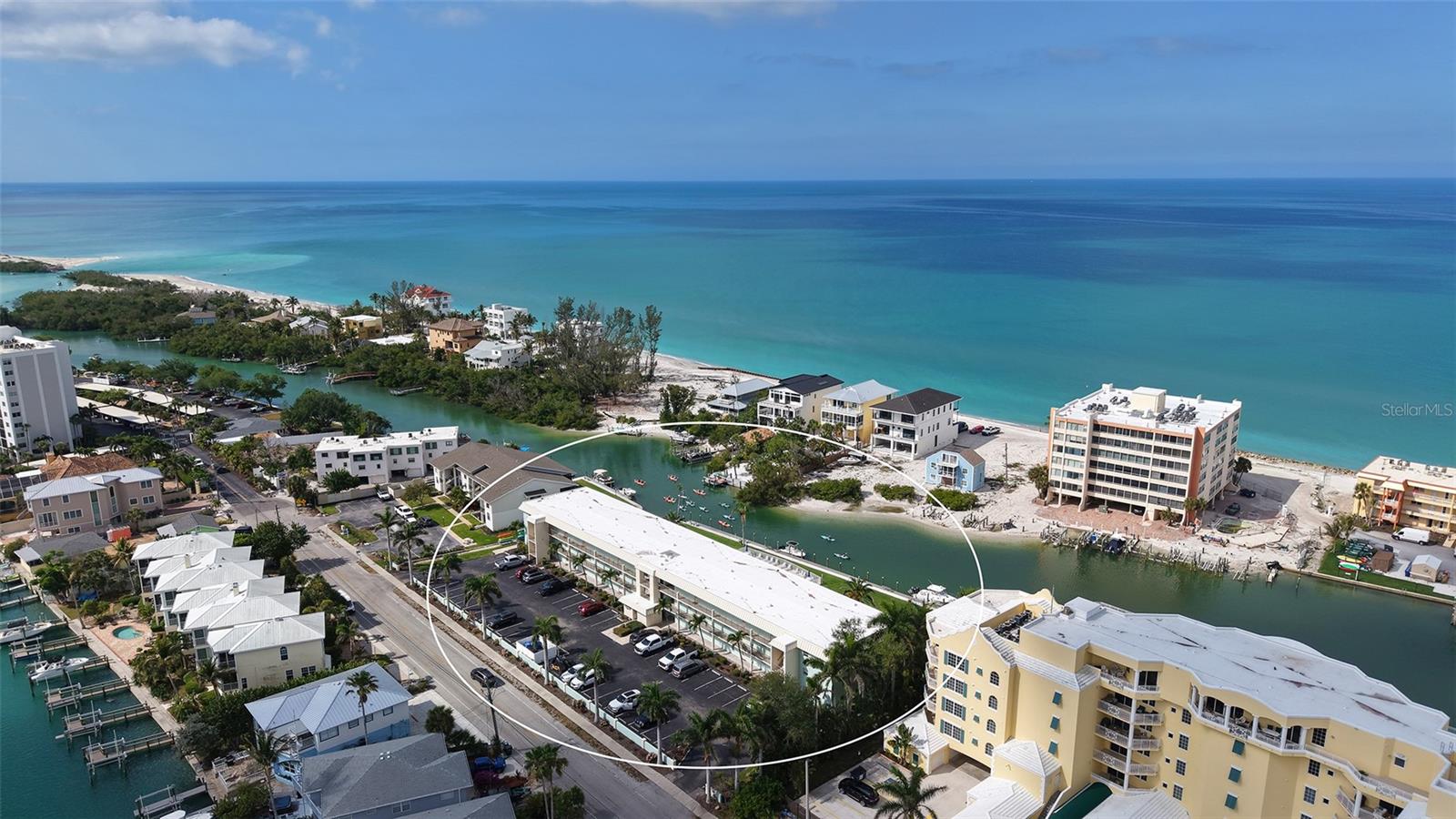 Introducing Inlet Apartments - Siesta Key, a charming, quaint coastal retreat for a tropical vacation or a beach getaway. This second-floor, one-bedroom, one-bath is quiet and peaceful on the Blind Pass Lagoon at far south end of Siesta Key and just beyond your sliding glass doors. You will be instantly captivated by views of paddleboarders and kayaks going by, plus a heated swimming pool and a partial view of the Gulf. With 906 square feet, this residence is sold turnkey furnished, blending modern sophistication with relaxed coastal living. Contemporary new kitchen with new appliances, white quartz countertops, an oversized island, and crafted for effortless everyday living. The open-concept layout flows through the dining room, with a queen-size Murphy bed for extra guests, and living spaces, enhanced by luxury vinyl wood flooring and modern compact ceiling fans that adjust with touch of a button. Wake up to enchanting lagoon views in the tranquil primary suite, and beautifully updated bath. Go outside to a spectacular 200-square-foot screened lanai with pull-down shades for privacy, ideal for morning espresso, sunset cocktails or simply soaking in Siesta Key’s year-round beauty. There are convenient elevators, laundry facilities and assigned parking for each unit. HVAC in 2021, water heater in 2022. Life at Inlet boating amenities included private boat dockage for sailboats and powerboats up to 26 feet (first-come, first-serve basis). The Blind Pass Lagoon leads into Sarasota Bay and onto the Gulf. There are fishing, kayak storage and launch, waterfront pool, all just minutes from Turtle Beach and a short trolley ride to Crescent Key Village. This is more than a condominium at the beach, it’s a one-of-kind opportunity to own a piece of Siesta Key.