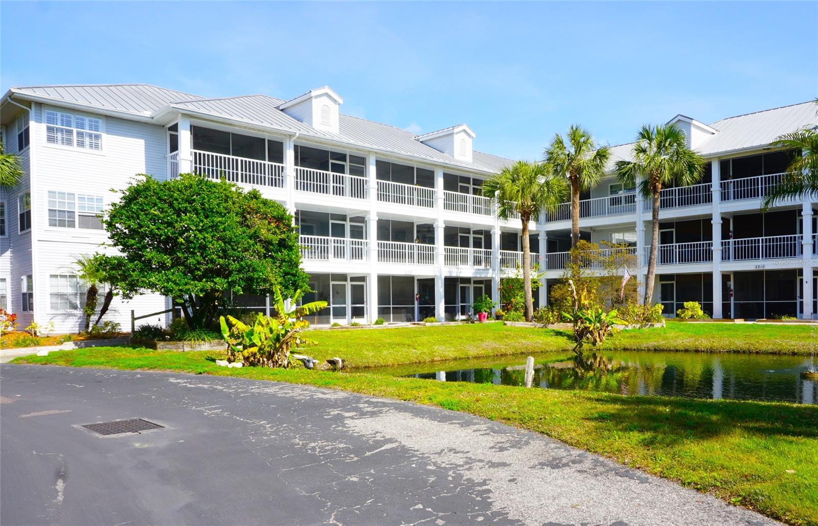 Owner may consider seller financing for this furnished ground level end unit studio condo located in the gated nudist/clothing-optional community of Paradise Lakes. This turnkey unit has neutral tile/colors throughout and central AC. The full kitchen features a smooth-top range, dishwasher, microwave, refrigerator, disposal, and plenty of cabinets and counter space. The bath has a raised vanity and tub/shower combo with sliding glass shower doors. A murphy bed provides comfy sleeping and stores out of sight in a cabinet with doors and built-in shelving. The living space has a small couch/table, flat screen TV, dresser, and a dining table with chairs. This cute condo has a large closet for clothing/linens, ceiling fan, and sliding doors. Enjoy outdoor living from the covered screened tiled lanai with water views. Bonus full-length/height cabinet with shelving along one wall of the lanai provides extra outdoor storage! Existing furnishings, appliances, decor, TV, kitchenware, and linens included. Located close to the resort amenities and ideal for owner or investor with great rental history. Buyer is responsible for verifying all information, details and dimensions. Condo association approval of Buyer is required including application, fee, and background check. Optional membership to Paradise Lakes Resort and amenities is not included in the monthly condo association fee.