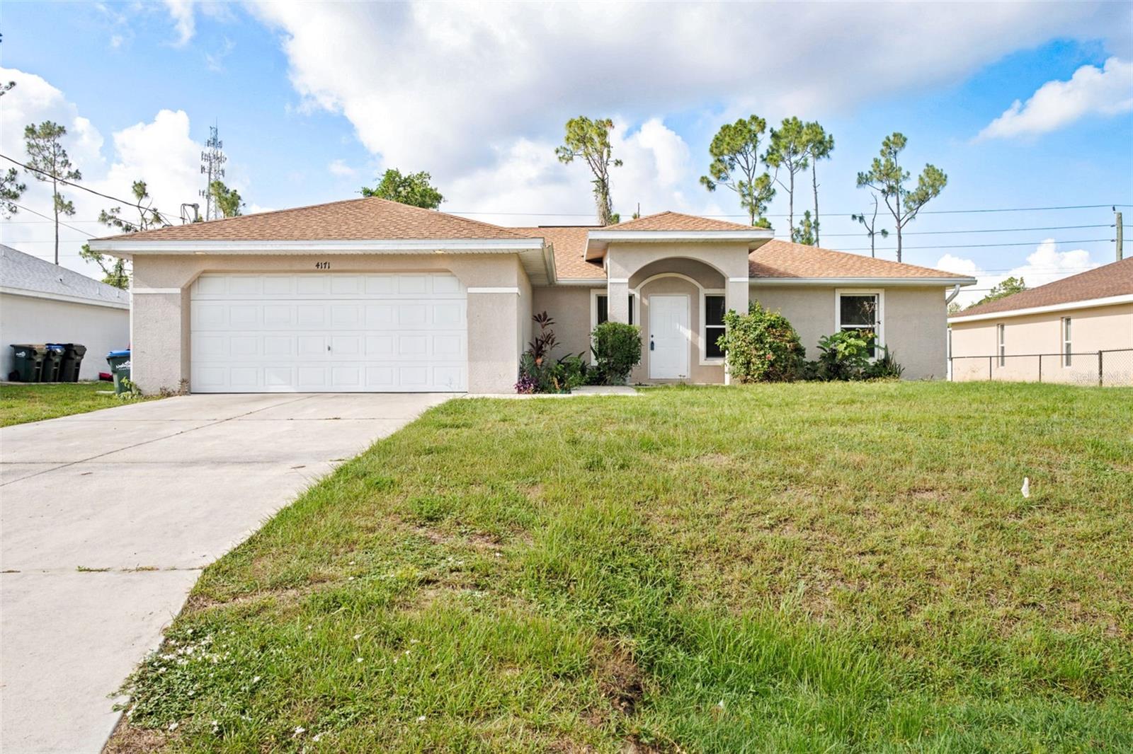 Virtually Staged. Welcome to this BEAUTIFULLY APPOINTED 2006 built 3 bedroom, 2 bath, 2 car garage home in DESIRABLE NORTH PORT with hard to find CITY WATER. Step inside through the soaring entryway and enjoy the bright, airy ambiance created by vaulted ceilings and recessed lighting throughout. This inviting split floor plan features hard surface flooring, just EASY TO MAINTAIN FLOORING that complements the home's elegant, fresh feel.The spacious living and dining areas are flooded with natural light, enhanced by sliding glass doors that open to the screened lanai, perfect for relaxing or entertaining year round. The newly renovated kitchen is a chef’s delight with raised panel cabinetry, stainless steel appliances, granite countertops, and a convenient breakfast bar ideal for hosting anything from intimate dinners to large gatherings. Retreat to the SPACIOUS PRIMARY SUITE boasting TWO CLOSETS; huge walk-in closet and additional built in closet, private backyard views, and a well appointed ensuite bathroom. Two generously sized guest bedrooms provide comfort and share a unique Jack and Jill bathroom layout that visitors will feel relaxed in. Enjoy the screened lanai mornings through evenings under the stars, or envision adding your own pool in the ample backyard space. This home offers added savings and  convenience with hurricane shutters, NEW AIR CONDITIONING 2023, NEW ROOF 2023, INSIDE LAUNDRY, NO DEED RESTRICTIONS, and NO FLOOD INSURANCE REQUIRED. Prime location in North Port well situated near to many amenities. North Port has Myakka State Park and Myakkahatchee Creek Environmental Center Park with miles of great trails, horseback riding, hiking, bird watching, biking, water views and access. Close to PG airport, dining, shopping, Stadium and beaches, Warm Mineral Springs and Aquatic Center. Experience comfortable, effortless  everyday Florida living or seasonal get away with this bright and welcoming North Port home! DON'T LET THIS ONE PASS YOU BY, make your appointment to see this wonderful gem TODAY!