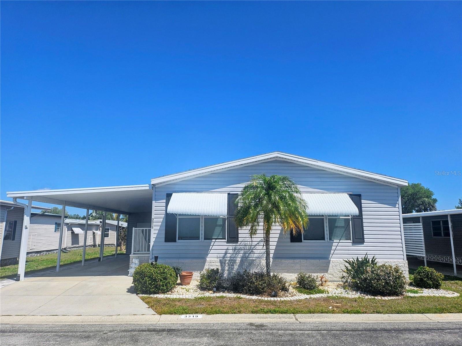 This home combines convenience and style in a welcoming well-maintained and vibrant gated community. 

ABOUT THE HOME: This beautifully designed 2008 Manufactured home has 1,278 sf of living space and an ideal layout with the 2-bedroom 2 bath split floor plan offering both privacy and comfort, featuring a spacious living room with high ceilings and windows, perfect for relaxing or entertaining. The home includes a formal dining area  with an oval dining set and a large kitchen with ample cabinets and a tile backsplash, pantry, refrigerator, stove, dishwasher and garbage disposal, complemented by a cozy breakfast dinette with a round table and seating for 4, a mounted flat screen TV and a sliding glass door leading to the carport—an ideal space for casual dining, games or working a puzzle. Just off the breakfast dinette are the full sized washer and dryer housed in a laundry closet. 
The large primary suite serves as a private retreat with a king bed, chest drawers, desk and walk in closet. This space is complete with an expansive en suite bathroom featuring dual sinks, a walk-in shower and WC nook. Sky lights in both bathrooms provide natural lighting. 
The large carport is roomy enough for 2 vehicles and/or an outdoor covered living area. The shed provides extra storage space.
Home is partially furnished.
Shingle roof replaced 1/2024 - Drywall in Living, Dining, and both Bedrooms 

ABOUT THE COMMUNITY: Oakwood Manor is located in the ONLY Resident Owned Park in the City limits of Sarasota!!
The gated 90 acre community boasts a low maintenance fee of $210/month - affording a big "bang for your buck" with its vast amenities, starting with the spacious Clubhouse outfitted with a full commercial cook kitchen, event stage, audio/visual, dance floor, state of the art fitness room, activities hall, library with books/movies/puzzles and a pool table. Outside recreation includes an extra large heated pool with a handicap ramp, a spacious kidney shaped hot tub, ample umbrella tables and lounge chairs and updated shower rooms. Oak trees shade the beautiful park area, picnic tables and a community grill. Additional amenities to enjoy are the community shuffle board courts, putt putt course, bocce ball, ping pong and corn hole. Please note that Oakwood is a 55+, no pet, no motorcycle Park.

AREA INTEREST: Oakwood Manor is a vibrant community with numerous social events and activities. It is conveniently located adjacent to Legacy Trail and 12 newer pickle ball courts. Just a short drive to our crystal sand beaches, downtown area, the marina, fishing pier, local golf courses, shopping, variety of restaurants, the museum, SRQ airport, SMH and Doctors hospitals.