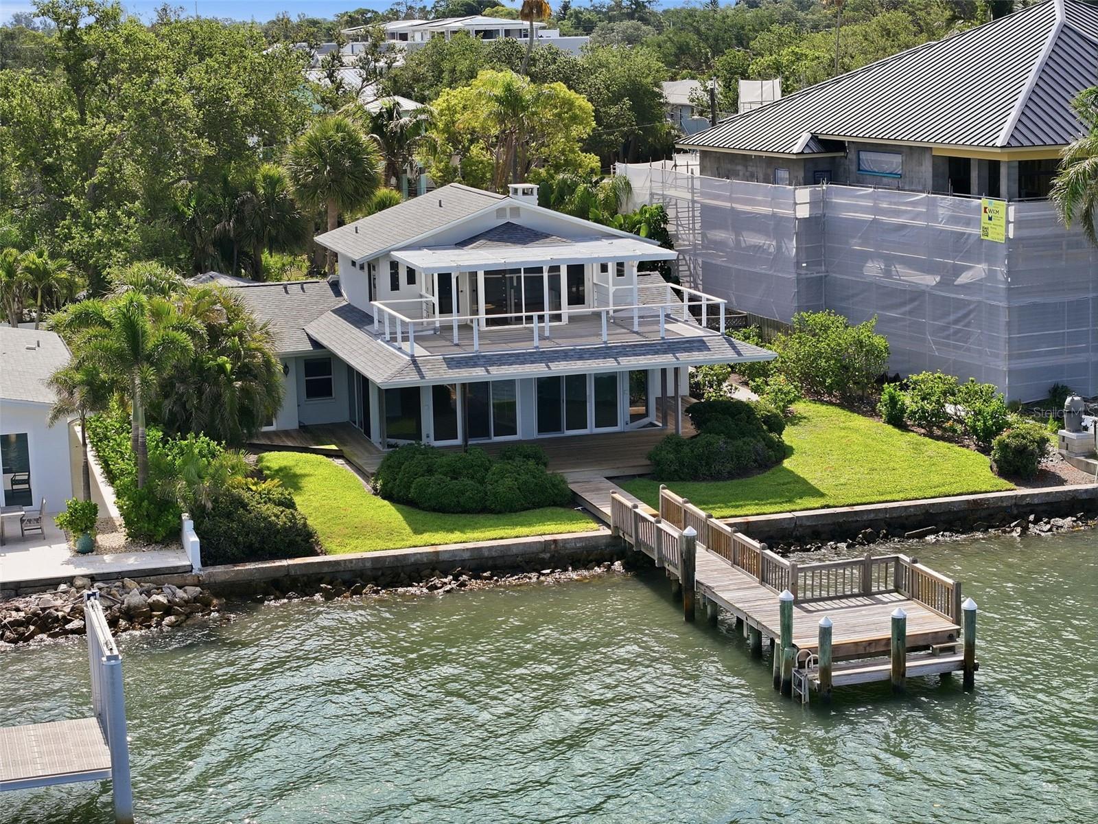 Imagine waking up every morning to the sparkling waters of the Intracoastal Waterway stretching endlessly before you, boats and dolphins gliding past your private dock, and the iconic Clearwater Beach skyline painted across the horizon. This is not a vacation — this is your everyday life.

The heart of this home is a spectacular 975-square-foot great room wrapped in floor-to-ceiling glass, delivering unobstructed 180-degree panoramic views, a dramatic spiral staircase, and multiple sliding glass doors that open directly to the waterfront. A wood-burning brick fireplace, chef's kitchen with hardwood cherry cabinetry and granite island, and sun-drenched living spaces make this home as comfortable as it is stunning.

The second-floor master suite is a true waterfront retreat with hardwood floors, a private waterfront balcony, and a spa-inspired en-suite bath featuring dual vanities, a jetted soaking tub, glass-enclosed shower, and walk-in California Closet. Two additional bedrooms each have their own en-suite baths and unique character.

On the water side, a covered rooftop pergola deck, private wooden dock, and lush tropical landscaping set the stage for the ultimate Florida waterfront lifestyle. Whether you are entertaining at sunset or casting a line from your own backyard, 1832 Venetian Point delivers a once-in-a-generation opportunity to live life on the water.