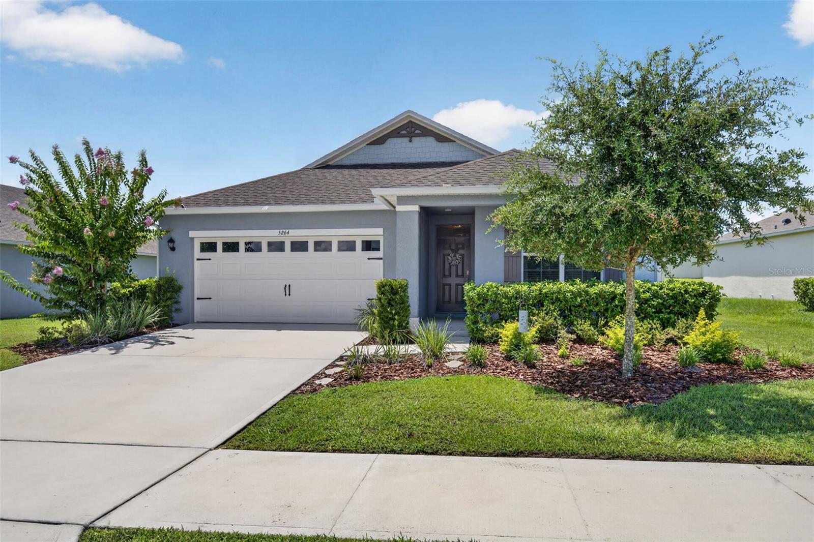 MODEL HOME STYLE without the price tag! This METICULOUSLY maintained 3 bedroom, 2 bath single-story home offers sophistication and charm LOCATED JUST MINUTES FROM HISTORIC DOWNTOWN MOUNT DORA. As you step inside, you’re greeted with a light and bright, open-style layout designed for both relaxed living and effortless entertaining. The flow is seamless with 2 bedrooms just off the hallway (one is currently used as an office w/a decorative fireplace). Then it opens into the Family Room and Kitchen. The kitchen offers stylish cabinetry, granite  countertops and upgraded lighting. The island is large enough to seat 3 and the custom pantry is a chef’s dream. The adjacent generous-sized family room helps create a balance of style, space, and everyday functionality. The dining area has a beautiful model-grade accent wall with designer lighting and is large enough for a to seat 6+. The primary bedroom offers views of the EXPANSIVE FENCED BACKYARD.  The SPA-INSPIRED ensuite bath boasts sophistication with an upgraded shower and double vanity sinks.  There’s a generous sized walk in closet too. The BACKYARD offers an ambiance of peace that allows you to sit back and enjoy a favorite meal or beverage in your screened patio accented by brick pavers. It’s a great place to view a fantastic sunset sky! Additional home features include….smart home security system, house gutters, remote controlled ceiling fans, attic stairs, inside laundry room with built in cabinets, and tilt-in windows (easy for cleaning). The house is 3 DOORS FROM THE COMMUNITY CENTER where all residents enjoy convenient amenities including a sparkling pool, 2 playgrounds, fitness course and walking trails. You’ll love the convenience of being just minutes from the vibrant shops, dining, and waterfront charm of Historic Downtown Mount Dora. The coveted Round Lake Charter school within walking distance, and less than a 3 minute drive. And for golfers, you’re close to the renowned Country Club of Mount Dora which is open to the public. Orlando and Winter Garden are an easy 35 minute drive making it a prime location to still enjoy the peacefulness of country living and still be connected to the bustle of the city. Make it a priority NOT to miss this one, schedule your viewing today!