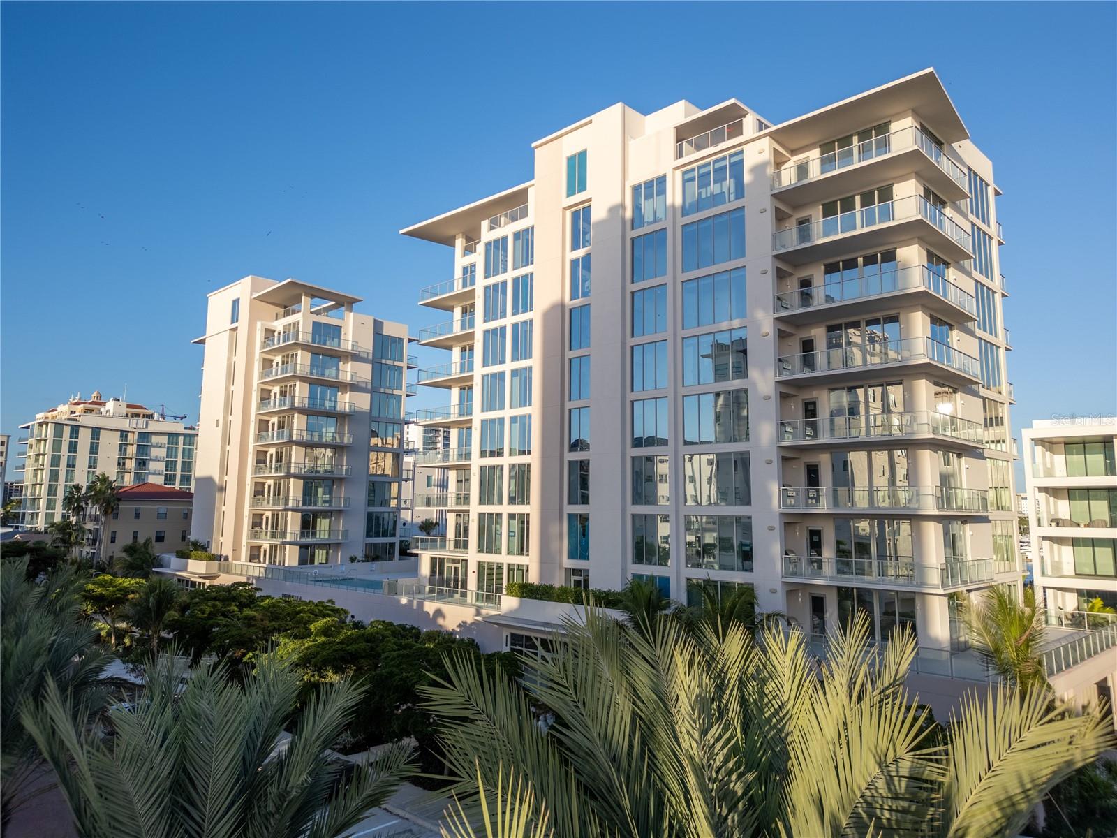 NEWLY COMPLETED Peninsula Sarasota is strategically located in the coveted Golden Gate Point neighborhood. The residences offer a serene retreat just moments from the energy and sophistication of downtown Sarasota. Each residence features a thoughtfully curated interior by Blu Interiors, showcasing contemporary modern design with soothing color palettes, soaring ceilings, and expansive wraparound terraces. Every detail reflects an uncompromising commitment to refined luxury. State-of-the-art kitchens are beautifully appointed with sleek European cabinetry, gas cooktops, and elegant quartz countertops, complemented by premium Wolf and Sub-Zero appliances. Additional highlights include hardwood flooring throughout, floor-to-ceiling windows that flood the interiors with natural light, and a gas grill on each private terrace—perfect for effortless entertaining. The spacious owner’s retreat is designed as a private sanctuary, offering generous walk-in closets, dual vanities, a soaking tub, and an oversized walk-in shower for spa-like relaxation. Residents enjoy the ease of on-site concierge services and secure, access-controlled underground parking for two vehicles, complete with an EV charging station. From your private foyer, a dedicated elevator provides direct access to exceptional amenities, including a resort-style swimming pool and a state-of-the-art fitness center on the second floor. The elegant owner’s club room overlooks the pool and features private wine storage for each residence, while the communal rooftop terrace invites unforgettable gatherings with sweeping panoramic and sunset views. Peninsula Sarasota presents a truly sophisticated lifestyle within a lush, tropical setting—just minutes from Sarasota’s renowned arts, culture, dining, and some of the nation’s finest beaches. This is a rare opportunity to elevate your living experience. Call today to schedule a private presentation and tour.