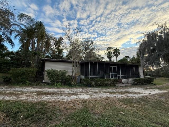 Private Central Florida property offering a 3-bedroom, 2-bath main residence (1990, 1,728 sq ft), a 1-bedroom, 1-bath guest cottage (2016, 504 sq ft), and over 6 acres of landscaped grounds with former working nursery features. Located at the end of a cul-de-sac near The Villages, Marion County amenities, and I-75, this homestead provides both privacy and convenience.

Designed and maintained by a Master Gardener, the property includes winding paths, ponds, mature ground cover beds, and multiple areas suitable for gardening, hobby farming, or business use. The layout and acreage support a variety of lifestyle or income-producing possibilities, including multigenerational living, guest accommodations, or revitalizing nursery operations.

The main home has received several recent updates, including a new septic system and drain field, renovated kitchen, updated master bathroom with Jacuzzi tub, refreshed master bedroom, upgraded flooring, and improvements to the home’s structural foundation. The guest cottage, constructed in 2016, offers additional living space for visitors, extended family, or rental use.

Additional property highlights include ample outdoor space, mature landscaping, and the unique combination of residential living with agricultural or nursery potential. This location offers convenient access to shopping, services, dining, medical facilities, and major roadways while maintaining a peaceful and secluded setting.

This listing represents an opportunity for buyers seeking acreage, privacy, flexible-use structures, and proximity to Central Florida destinations. Full list of updates and features available upon request.

Owner offers to cover closing costs.