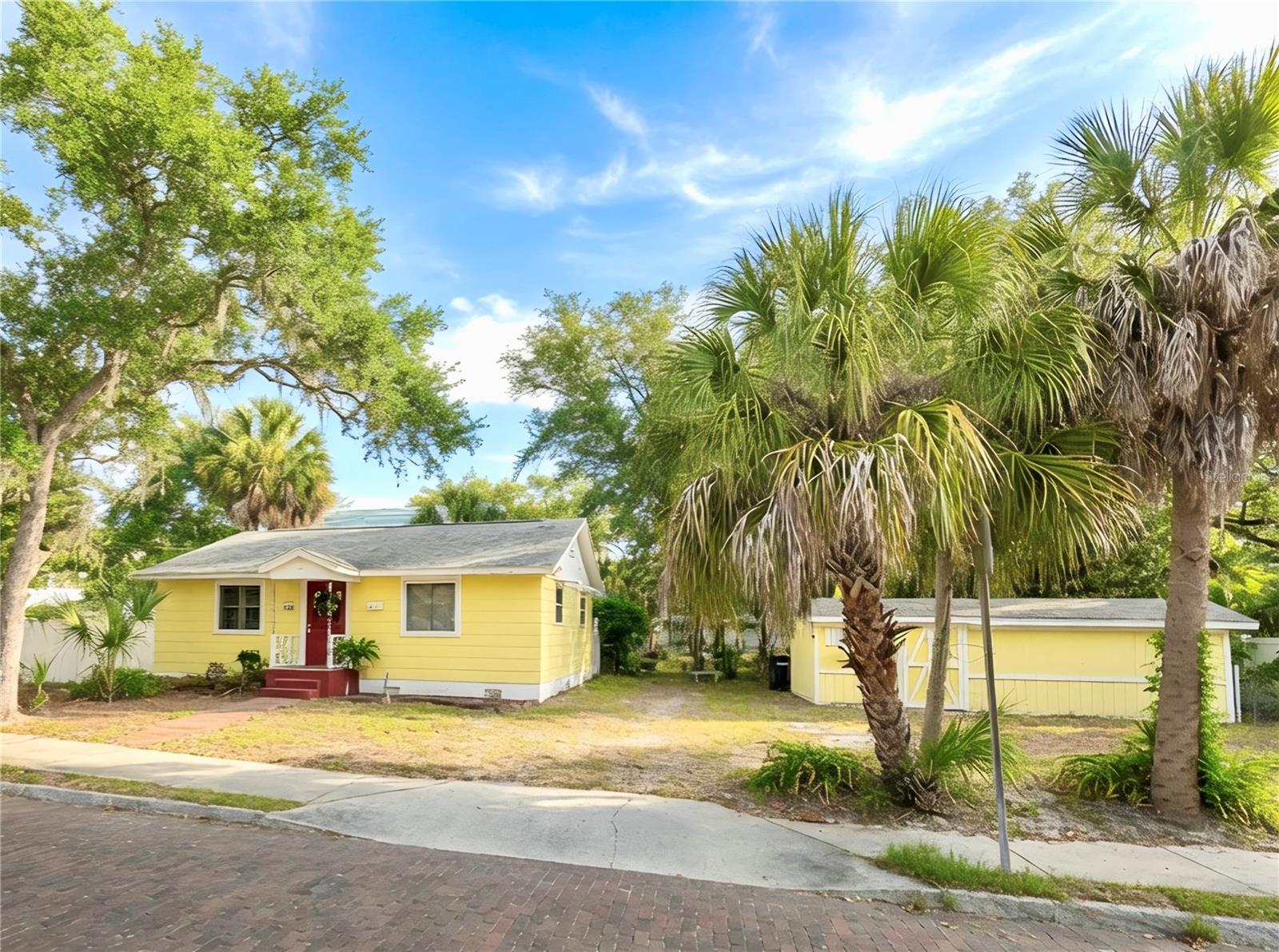 One or more photo(s) has been virtually staged. Ideal corner lot highly walkable to downtown Safety Harbor events and the fun lifestyle is just .3 miles away. Inside, the home features beautiful real wood floors, plantation shutters, custom built-in bookshelves, and warm wood accents that create an inviting and timeless living space. The kitchen open kitchen and dining room combo makes everyday living and entertaining comfortable and functional. Both bedrooms feature wood flooring and plenty of natural light, providing cozy and flexible spaces for rest, work, or guests. The updated bathroom includes new tile, a new vanity, updated fixtures, and a refreshed shower/tub stall for a clean and contemporary feel. Important system upgrades add peace of mind, including a 2022 Trane A/C, tankless water heater, newer electrical panel, and new front and back doors installed in 2024. Outside, enjoy a fully fenced backyard perfect for pets, gardening, or relaxing outdoors. The property also features a storage shed, extra off-street parking, and a convenient rear access ramp. Located less than half mile to walkable downtown Safety Harbor and the waterfront, residents enjoy easy access to parks, a marina, local restaurants, boutique shops, year-round festivals, and the famous Safety Harbor Resort and Spa. Experience the charm and relaxed coastal lifestyle that make Safety Harbor one of Tampa Bay’s most sought-after communities.