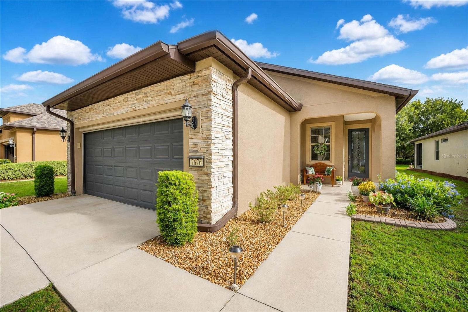 Welcome to this beautifully maintained Taft Street model located in the desirable Arlington neighborhood of Del Webb Stone Creek. Offering 2 bedrooms, 2 bathrooms, and a versatile flex room, this thoughtfully designed home combines comfort, functionality, and low-maintenance living.

Step inside to discover rich hardwood flooring that flows throughout the kitchen, main living areas, and flex room, creating a warm and inviting atmosphere. The open-concept floor plan is enhanced by granite countertops, abundant natural light, and ceiling fans throughout the home for year-round comfort. Plantation shutters in the kitchen add timeless style and charm while providing privacy and light control.

The flexible bonus room offers endless possibilities and can serve as a home office, hobby room, reading nook, or additional guest space. The primary suite provides a relaxing retreat and features a custom closet organizer designed to maximize storage and organization. A spacious guest bedroom and second full bathroom offer comfortable accommodations for family and visitors.

Additional upgrades include laundry room cabinetry for extra storage, a new water heater, an automatic garage screen door, an epoxy-coated garage floor, and a utility sink in the garage, adding convenience and functionality to everyday living.

Outdoor living is equally impressive. Relax on the screened lanai overlooking a private backyard with no rear neighbors, or enjoy Florida's beautiful weather from the extended paver patio—perfect for entertaining, grilling, or simply unwinding in a peaceful setting.

The exterior of the home has been freshly painted, enhancing its curb appeal and move-in-ready condition. As an added benefit, the HOA provides lawn maintenance, shrub trimming, irrigation system maintenance, and water for irrigation, allowing you to enjoy a truly low-maintenance lifestyle.

Enjoy all that Del Webb Stone Creek has to offer, including resort-style amenities, fitness facilities, golf, pickleball, tennis, social clubs, and a full calendar of activities. This exceptional home offers the perfect combination of comfort, privacy, and carefree living in one of Ocala's premier 55+ communities.