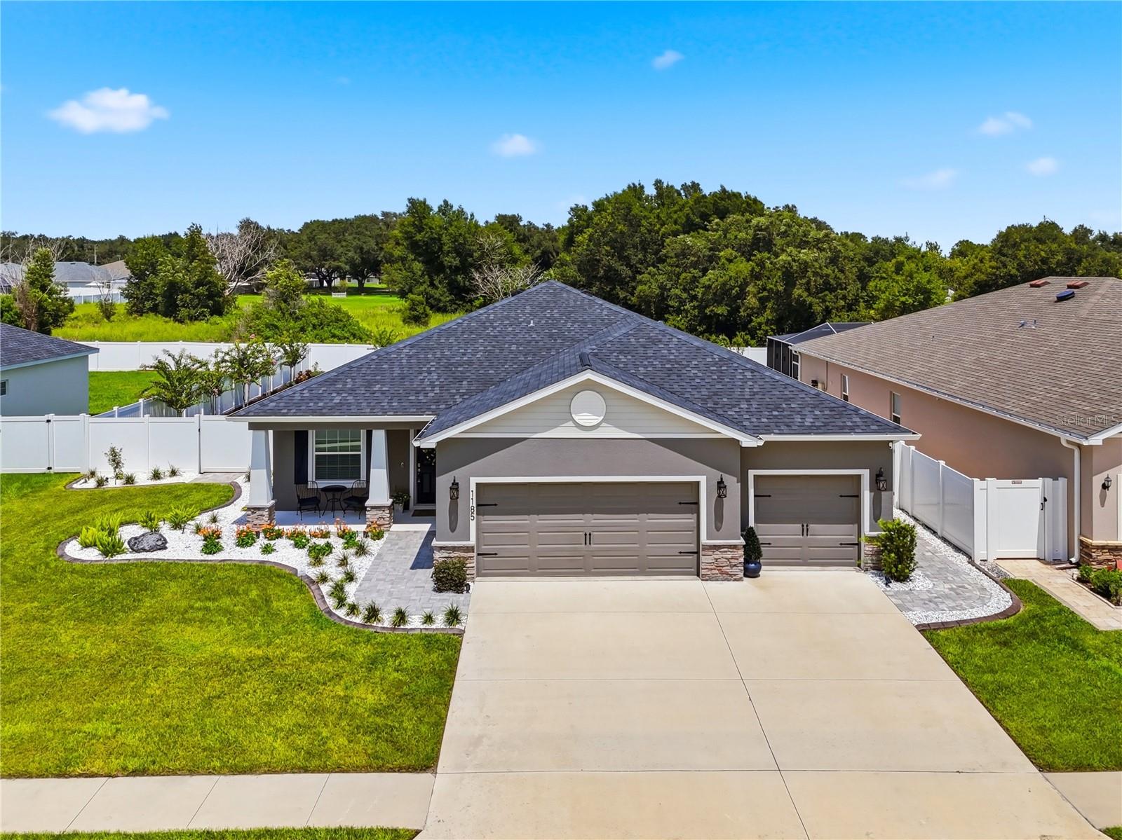If you've been waiting for the one home that truly stands above everything else in its price range, your search ends here. Better than new and extensively upgraded beyond anything the builder offers today, this extraordinary 2023-built residence in Chestnut Creek is the definition of turnkey luxury. Every inch of this home reflects exceptional craftsmanship, meticulous attention to detail, and an uncompromising commitment to quality. With well over $150,000 invested after construction—including a custom resort-style pool and spa that alone exceeded $120,000—this is a property that simply cannot be replicated at this price point.
Offering four bedrooms, two-and-a-half baths, a private office, and a three-car garage, the home makes an unforgettable first impression with meticulous landscaping, decorative landscape lighting, an extended paver walkway, epoxy-coated garage floors, and a fully fenced backyard. Inside, luxury vinyl plank flooring has replaced the builder-grade flooring throughout, complemented by upgraded baseboards, custom window treatments that remain, and carefully selected designer finishes that elevate every room. A private office with French doors provides the perfect work-from-home space, while the expansive open-concept floor plan offers effortless everyday living and entertaining.
The kitchen is both stunning and functional, featuring upgraded stainless Samsung appliances, an oversized quartz island with breakfast bar seating, abundant cabinetry, a spacious walk-in pantry, a touch-activated faucet, and seamless flow into the dining and living areas.
The spacious primary suite serves as a luxurious retreat with a walk-in closet featuring custom organizational systems, granite vanity, a soaking tub, oversized walk-in shower, and generous proportions. Three additional bedrooms provide flexibility for family and guests, while the upgraded half bath showcases custom shiplap detailing. Even the laundry room has been thoughtfully appointed with Samsung washer and dryer that convey with the home.
Step outside and discover what truly sets this property apart. Designed for a private resort feel, the backyard centers around a spectacular heated saltwater pool and spa featuring Jandy automation, an automated pool cleaner, expansive paver decking, a screened enclosure, and a covered lanai. Combined with lush landscaping and evening landscape lighting, the outdoor living space offers an extraordinary setting for entertaining or simply relaxing in complete privacy.
Additional premium upgrades include a radiant roof barrier for enhanced energy efficiency, water softener, irrigation system, extensive garage storage systems that convey with the home, epoxy garage flooring, and countless additional improvements that would cost a substantial amount of time and money to duplicate today. Even the three-car garage has been transformed into an exceptionally organized and highly functional space with professional storage solutions ideal for vehicles, hobbies, and equipment.
Located in the desirable Chestnut Creek community, you'll enjoy the benefits of newer construction while remaining just minutes from downtown Winter Haven, shopping, restaurants, Winter Haven Hospital, Polk State College, and the renowned Chain of Lakes. Convenient access to the Polk Parkway and I-4 places Lakeland, Tampa, Orlando, major employers, international airports, and Central Florida attractions within easy reach. Schedule your appointment today!