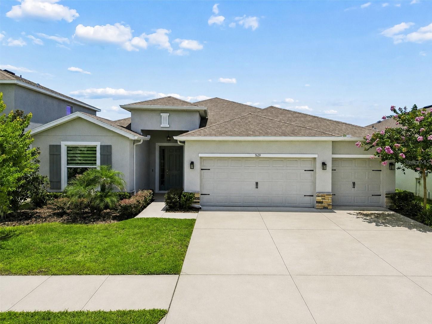 Welcome to this beautifully maintained home located in the desirable community of DEERBROOK
in Land O' Lakes. Built in 2024, this thoughtfully designed home offers 4 BEDROOMS, 3 FULL
BATHROOMS, A TRUE 3-CAR GARAGE, AND OVER 2,500 SQ FT OF LIVING SPACE, all situated on
a PREMIUM 60-FOOT-WIDE HOMESITE with breathtaking POND AND CONSERVATION VIEWS.
Surrounded by endless trees and offering COMPLETE BACKYARD PRIVACY WITH NO REAR
NEIGHBORS, this setting is truly one of the home's most EXCEPTIONAL features. Even better, the
sought-after HAWTHORNE FLOOR PLAN is no longer offered by the builder, making this an
increasingly rare opportunity.
Enhanced with OVER $30,000 IN OWNER IMPROVEMENTS, this home showcases thoughtful
upgrades throughout, including CUSTOM DESIGNER BLINDS AND WINDOW TREATMENTS, a
designer kitchen backsplash, cabinet hardware throughout, GUTTERS surrounding the home,
upgraded exterior lighting, extended tile flooring in the primary suite, a NEW REFRIGERATOR, and
a FULLY FENCED BACKYARD. The covered lanai has also been ENHANCED with a MOTORIZED
RETRACTABLE SCREEN SYSTEM ($10,000), allowing you to enjoy the space year-round while
taking in the ONE OF A KIND VIEW.
This home showcases an open-concept floor plan filled with natural light, HIGH CEILINGS, and
designed for both everyday living and entertaining. The spacious great room flows seamlessly into
the dining area and kitchen, creating the ideal gathering space. The kitchen features QUARTZ
COUNTERTOPS, STAINLESS STEEL APPLIANCES, AN UPGRADED BACKSPLASH, AMPLE
CABINETRY, A WALK-IN PANTRY, AND A LARGE CENTER ISLAND with plenty of seating.
The private owner's retreat offers breathtaking views and upgraded tile flooring that extends into
the bedroom and closets, spacious walk-in closets, and an ensuite bath with dual vanities, a
soaking tub, and separate shower. One of the most desirable features of this floor plan is the
PRIVATE GUEST SUITE WITH ITS OWN ENSUITE BATHROOM, providing an ideal setup for guests,
multi-generational living, or anyone needing additional privacy.
Step outside and enjoy one of the home's standout features. The FULLY FENCED BACKYARD
overlooks endless pond and conservation views, creating a peaceful outdoor setting with added
privacy. The thoughtful retractable screen upgrade transforms the lanai into an outdoor living
room, providing comfort and flexibility throughout every season. The combination of the oversized
60-FOOT HOMESITE, mature tree-lined backdrop, and lack of rear neighbors creates a peaceful
setting that is INCREASINGLY DIFFICULT TO FIND IN NEWER CONSTRUCTION COMMUNITIES.
Residents of DEERBROOK enjoy access to a COMMUNITY POOL, CLUBHOUSE, PLAYGROUND,
DOG PARK, AND WALKING TRAILS, all conveniently located near US-41, the Suncoast Parkway,
Tampa International Airport, shopping, dining, schools, and everyday conveniences. Combining
MODERN CONSTRUCTION, A FUNCTIONAL FLOOR PLAN, PREMIUM PRIVATE VIEWS, AND
EXTENSIVE UPGRADES, this home is an exceptional opportunity in one of Land O' Lakes' growing
areas.