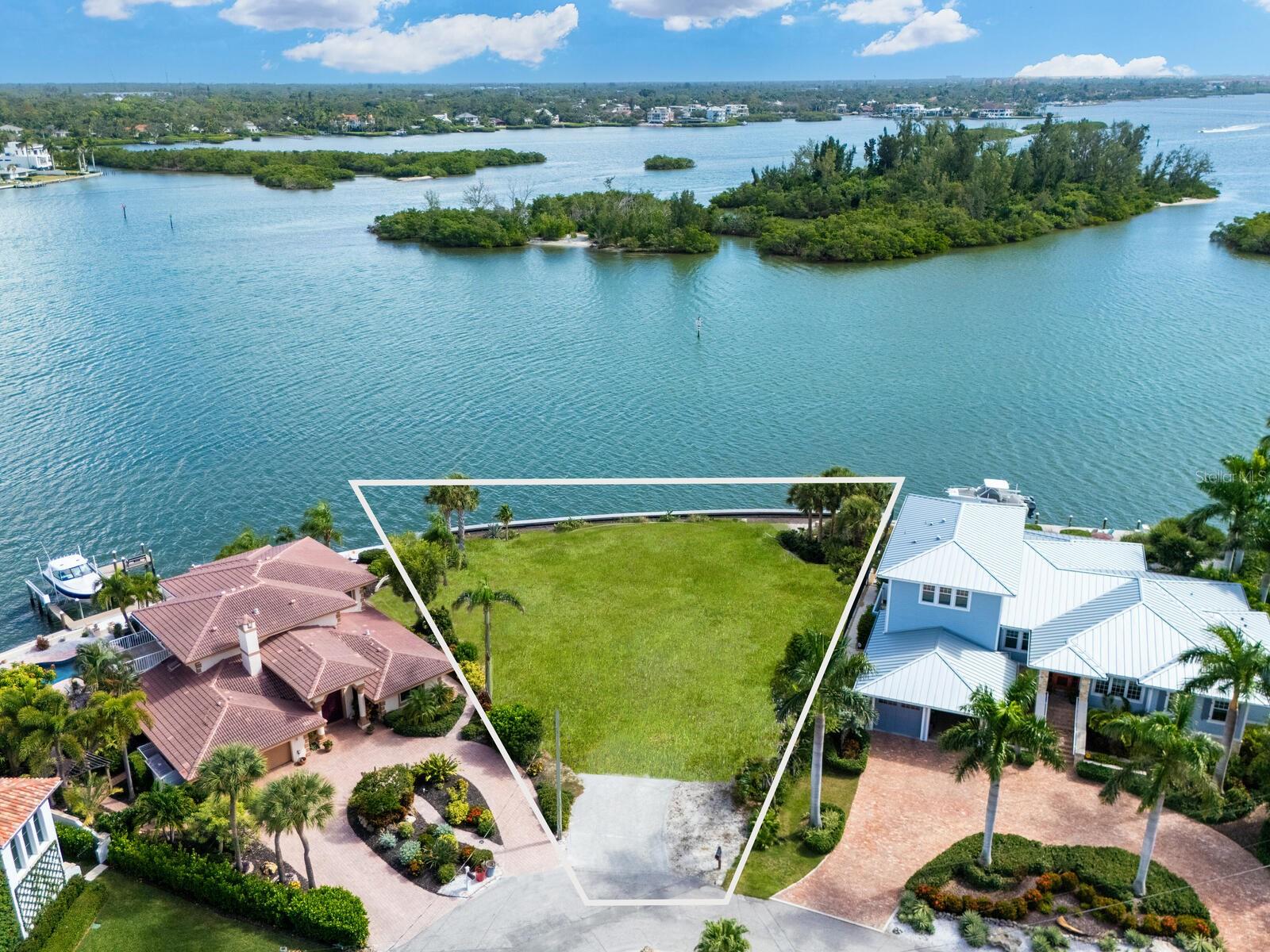 Zoning confirmation letter in from City of Sarasota. Ready for permitting and your custom dream home. This waterfront gem fronts Roberts Bay, facing Edwards Island, and offers unobstructed 180-degree views of dolphins, various bird species, and manatees. It's a perfect canvas for creating your customized residence. Located on the prized northern tip of Siesta Key, nestled on the Freeling Drive peninsula, this exquisite parcel blends sophistication with coastal living. Bay Island is renowned for its admired homes and architectural beauty, redefining island luxury along one of the area’s most pristine waterways. The oversized homesite is just under 15,000 square feet and features an impressive 155 feet of brand-new two-foot-elevated seawall, offering stunning panoramas. This location is ideal for boating and fishing enthusiasts, or for simply enjoying breathtaking sunrises and sunsets in unmatched natural beauty. Access on and off the island is easy, with Siesta Key Village's vibrant shops and restaurants, as well as the world-renowned Siesta Key Beach, just minutes away. Downtown Sarasota, with its galleries, theater, and fine dining, is also a short drive. Opportunities like this are rare, making this property a true gem for anyone seeking the ultimate waterfront address where privilege and prestige are embedded in an affluent lifestyle. I highly recommend experiencing the magic of this property for yourself. Choose any architect or builder to make your dreams come true. Owner will consider financing.