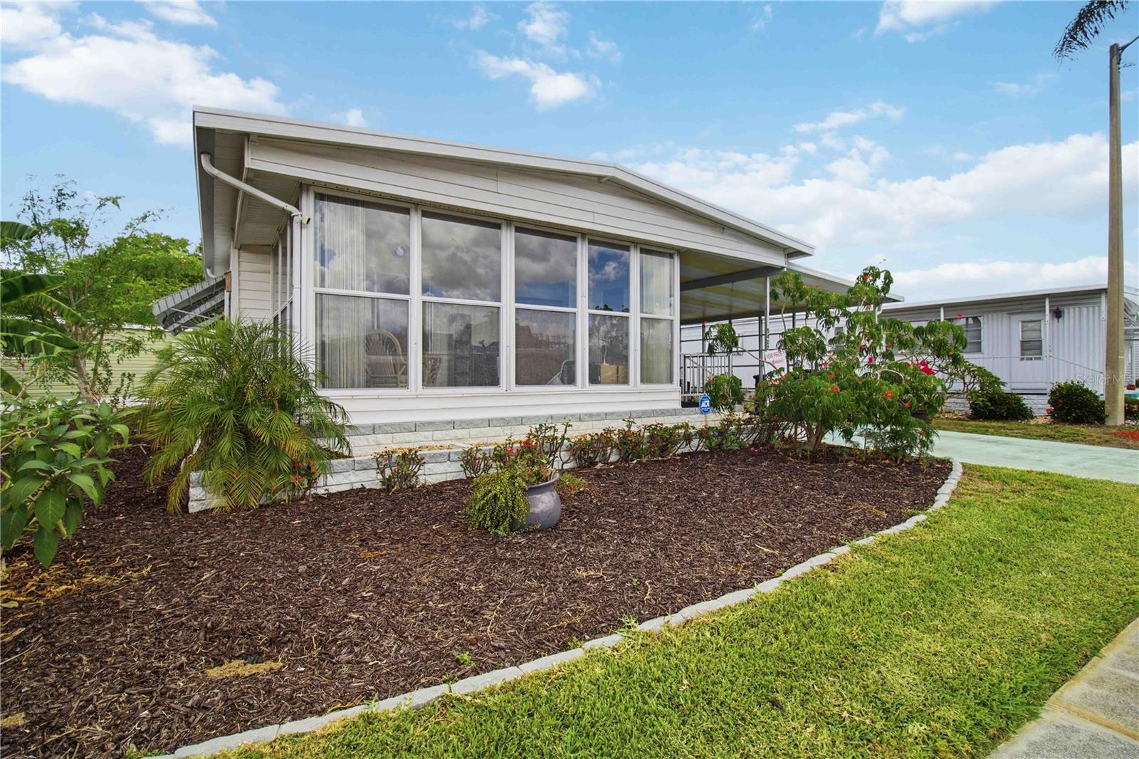 Welcome to 5402 Chateau Lane, a beautifully updated turnkey home located in the highly sought-after 55+ community of Chateau Village in Bradenton. Situated on a rare oversized corner lot and outside of a flood zone, this fully renovated 2-bedroom, 1-bath residence offers the perfect combination of comfort, convenience, and low-maintenance Florida living. With HOA fees of just $250 per month, you'll enjoy an affordable lifestyle with more time to relax and enjoy all that the Gulf Coast has to offer.

Inside, the home has been thoughtfully reimagined with high-end finishes and modern upgrades throughout. Luxury vinyl flooring flows seamlessly from room to room, while the spa-inspired bathroom features a relaxing Japanese soaking tub, separate walk-in shower, and dual rainfall shower heads. The gourmet kitchen is equally impressive, showcasing leathered granite countertops, solid wood two-tone cabinetry, and designer finishes that blend style with everyday functionality.

Step outside to your own private garden oasis, thoughtfully designed with pollinator-friendly landscaping that creates a peaceful setting for morning coffee, afternoon reading, or relaxing evenings outdoors.

Recent improvements provide exceptional peace of mind, including a new HVAC system (2025), tankless water heater (2024), electrical panel (2024), roof sealing (2024), and updated lanai windows and hurricane protection enhancements (2025).

Chateau Village is ideally positioned near everything you need for an active and enjoyable lifestyle. Residents are just minutes from shopping, dining, grocery stores, medical offices, and major healthcare facilities. The beautiful Gulf beaches of Anna Maria Island are a short drive away, offering some of Florida's most stunning waterfront scenery. Nearby destinations such as Bradenton, Sarasota, St. Petersburg, and Lakewood Ranch provide endless opportunities for dining, entertainment, cultural events, golf, and recreation.

Convenient access to US-41, State Road 70, and Interstate 75 makes travel throughout the region simple, while nearby public transportation options provide added convenience for shopping, appointments, and local travel.

Whether you're looking for a full-time residence or a seasonal retreat, this exceptional turnkey home offers the perfect blend of modern upgrades, affordability, and an unbeatable location in one of Bradenton's most desirable 55+ communities.