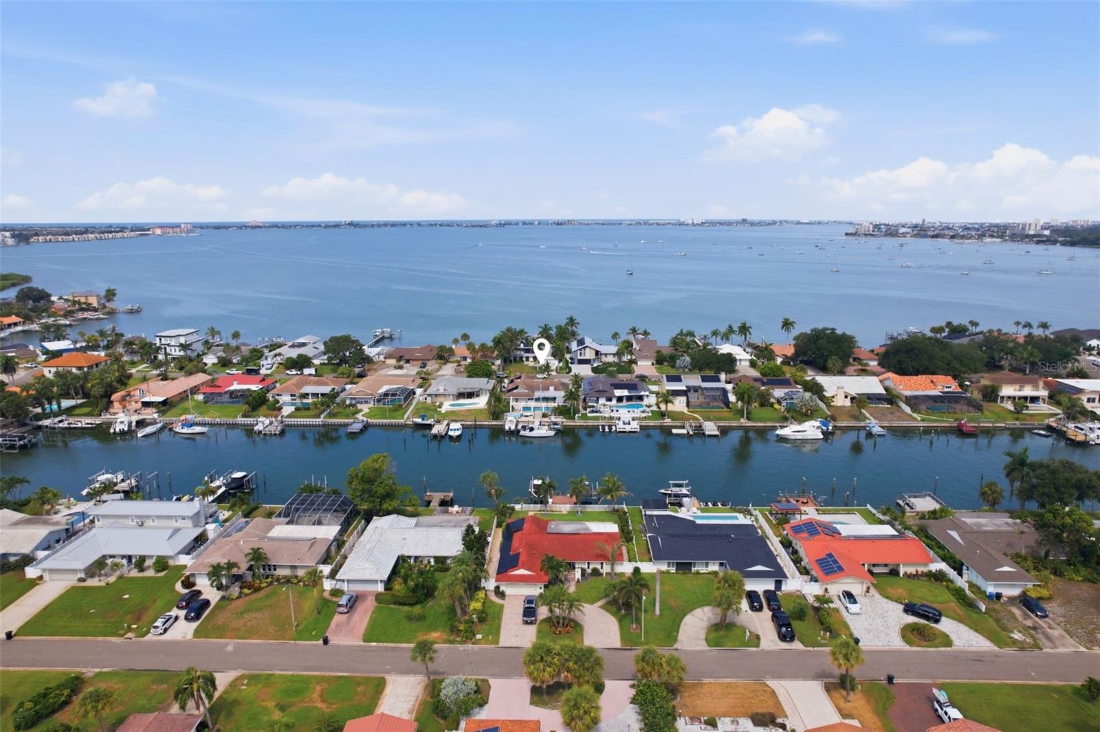 SALT WATER PARADISE, REIMAGINED! A Boater's Dream on A+ Water in Broadwater, with a BRAND NEW 2026 Dock and DUAL Boat Lifts!

This fully renovated waterfront pool home sits on 80ft of seawall with deep sailboat water and quick, no-bridge access to the Intracoastal, Boca Ciega Bay and the Gulf of Mexico. The all-new 394sqft composite dock (2026) rides on 22 wrapped pilings and features TWO boat lifts, a 10,000lb. and a newly added 7,000lb., both wired with 30/50 amp service, water and 110V outlets for larger vessels. Broadwater is prized for its excellent boating/fishing water, the Skyway Marina District, and easy access to Fort De Soto, downtown St. Pete, Tampa, and the beaches.

An ENTERTAINER'S DREAM! Dock the boat and walk guests straight to the party. Mix drinks at the wine bar off the kitchen, host at the fully equipped bonus room bar with kegerator, icemaker and dual beverage fridges, then spill out to the pergola by the pool, wired with fans and lighting, for sunset dinners and gatherings that flow effortlessly from indoors to out.

Storm-hardened and move-in ready: hurricane-rated tile roof (2018), impact Pella windows, hurricane garage doors, an upgraded 400amp electrical service with whole-home surge protection, and interconnected smoke/CO detectors with AFCI protection. New Provia hurricane exterior doors and kitchen window (2025).

The pool has been converted to saltwater with a new filter, pump and controller, plus a solar heater/cooler. Mature palm landscaping and a new stamped concrete driveway complete the curb appeal.

Easy-flowing split floor plan with 5 bedrooms, 3 baths, an open living/dining/kitchen area with skylight and fireplace, a 5th bedroom currently used as an office, oversized inside laundry, an inside grill, and a spacious primary suite with two walk-in closets and a spa-like bath. Kitchen features granite counters, wood cabinetry, stainless appliances, glass tile backsplash and a breakfast bar. Travertine flows throughout.

Nearly $300,000 invested since 2018, including a new whole-home A/C duct system, heat pump and air handler, water heater with 12-year warranty, water softener, UVC air purification, hot water recirculation and irrigation.

A rare, turnkey waterfront estate on A+ boating water. Come live the Florida waterfront lifestyle!