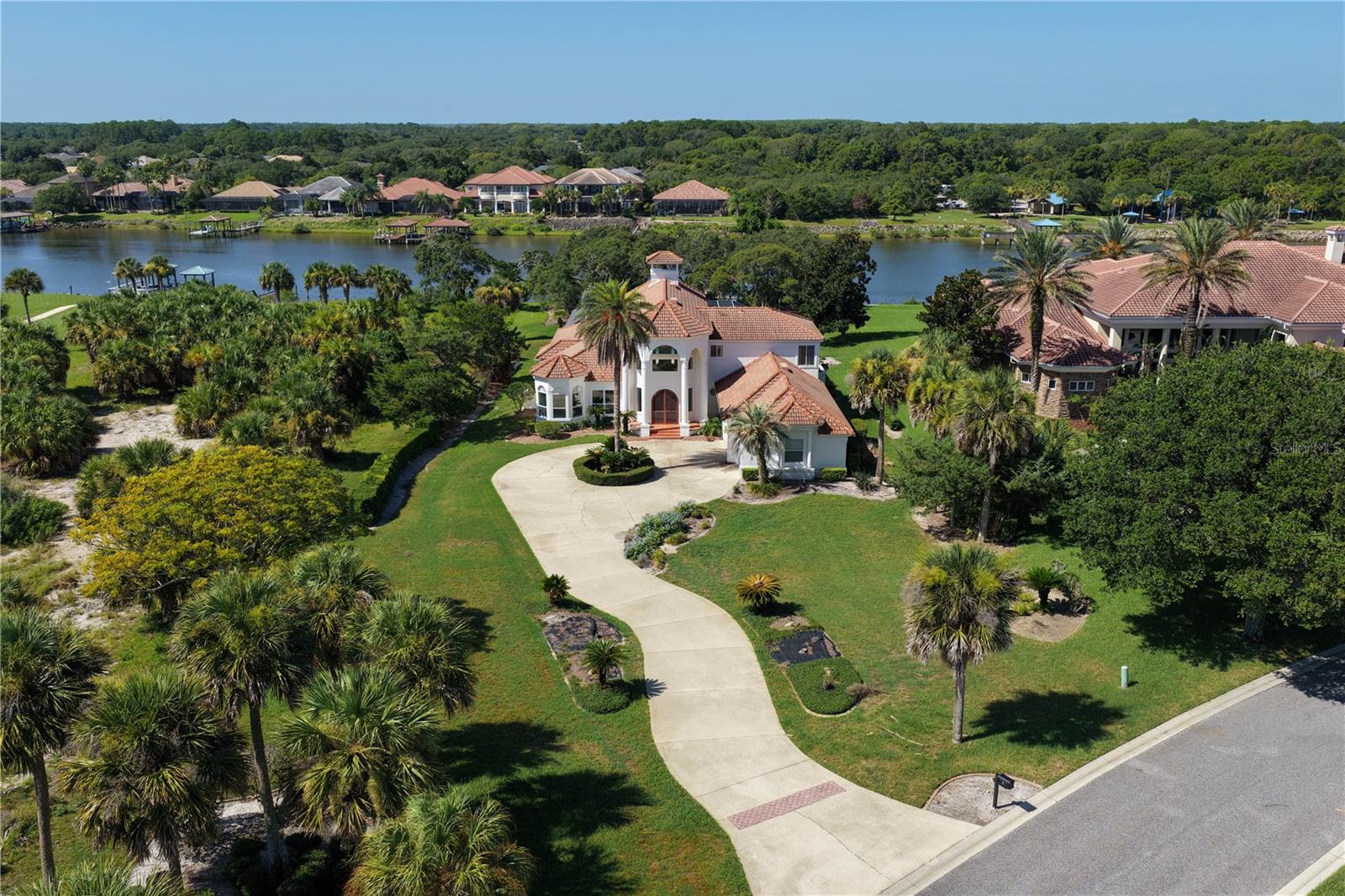 A rare opportunity to own an Intracoastal estate within the exclusive gated community of
Island Estates at Hammock Dunes.

Perfectly positioned on more than an acre along the Intracoastal Waterway, this custom residence offers approximately 4,680 square feet of living space, featuring four bedrooms, four bathrooms, a three-car garage, along with a private boathouse with lift.

A graceful circular driveway welcomes you to a home defined by timeless architecture, grand proportions, and exceptional craftsmanship. The dramatic two-story foyer creates an unforgettable first impression with soaring ceilings, striking beam details, and expansive windows that fill the interior with natural light while drawing your eye toward the tranquil waterfront beyond.

Designed for both everyday living and effortless entertaining, the generous floor plan offers spacious gathering areas, remarkable ceiling volume, and a seamless connection between indoor and outdoor living.

The expansive waterfront setting, mature landscaping, and private boathouse create the ideal backdrop for embracing Florida's coastal lifestyle.

Located within one of Northeast Florida's most sought-after waterfront communities, Island Estates offers private beach access, while optional membership to Hammock Dunes Club provides championship golf, oceanfront dining, tennis, pickleball, fitness, and a vibrant social lifestyle.

Whether your vision is to thoughtfully enhance the existing residence or create a home that reflects your own style, opportunities like this are increasingly rare. Here, the foundation is already in place an extraordinary homesite, timeless architecture, and one of the most desirable waterfront settings in Hammock Dunes.

The next chapter is simply yours to write.