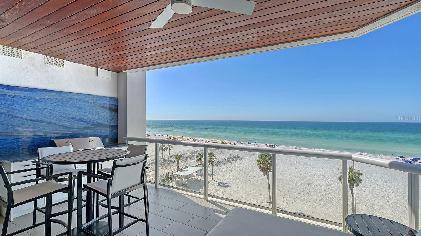One-of-a-Kind Gulf-Front Luxury at Ten35 Seaside! Welcome to Unit #503—an extraordinary, custom-designed Gulf-front residence on South Siesta Key. Thoughtfully reimagined with over $400,000 in bespoke upgrades, this one-of-a-kind home delivers a level of luxury, craftsmanship, and exclusivity rarely offered.

From the moment you arrive, convenience meets prestige with two deeded parking spaces and one of only eleven private storage lockers in the building. Inside, a reconfigured layout maximizes sweeping, unobstructed Gulf views, while curated finishes include exquisite precious stone slabs, advanced AV and home automation, and custom acoustic paneling for a truly immersive living experience.

The chef’s kitchen is a showpiece, featuring a backlit precious stone backsplash, premium appliances, and custom cabinetry designed for both beauty and performance. An adjacent wet bar—complete with custom shelving, a full-size Sub-Zero wine refrigerator, and beverage cooler—sets the stage for effortless entertaining.

The Gulf-front primary suite is a serene retreat with panoramic views, a spacious walk-in closet, and a spa-inspired en-suite bath with dual vanities and an expansive walk-in shower. Three additional guest suites provide luxurious comfort and privacy for family and guests alike.

Outdoor living is equally impressive, with a generous Gulf-front terrace and custom outdoor kitchen, ideal for alfresco dining while taking in the sights and sounds of the shoreline.

Residents of Ten35 Seaside enjoy a resort-style lifestyle with beach attendants, a Gulf-front pool, fire pits and grilling areas, a state-of-the-art fitness center, on-site property management, and an optional on-site rental program offering income potential.

A rare offering at one of Siesta Key’s most coveted addresses, Unit #503 represents the pinnacle of Gulf-front living—where exceptional design, unparalleled customization, and breathtaking views come together. This is more than a residence; it’s a coastal masterpiece.