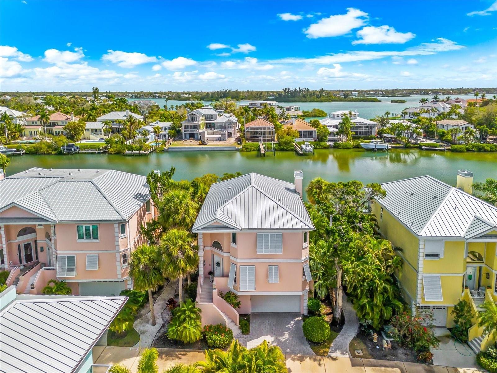 Welcome to coastal luxury living in the exclusive Hamilton Club community on Siesta Key. This beautifully updated 3-bedroom, 3.5-bath waterfront residence offers an exceptional blend of elegance, comfort, and boating convenience in one of the island’s most desirable locations.

Designed for effortless everyday living and entertaining, the home features a private elevator, impact-rated windows and doors, and a private 10,000-lb boat lift with quick access to Sarasota’s waterways and the Gulf beyond. A spacious screened lanai overlooking the water provides the perfect setting for morning coffee, evening cocktails, and year-round enjoyment of peaceful coastal breezes.

Each spacious bedroom includes its own en-suite bath, offering privacy and comfort for both residents and guests. Thoughtfully updated throughout, the residence showcases renovated bathrooms completed in 2022–2023, kitchen enhancements in 2023, updated lighting, and beautiful new wood flooring, all contributing to a refined coastal aesthetic. Additional improvements include a new water softener and water pressure pump installed in 2025 for added functionality and peace of mind.

Offered furnished or unfurnished, the home provides flexibility for immediate enjoyment or personalization to suit your style. Hamilton Club residents will also benefit from upcoming community landscaping improvements this summer and exterior building painting scheduled for 2027, both covered by HOA dues.

Ideally located just minutes from Siesta Key’s world-renowned beaches, dining, shopping, and entertainment, this exceptional waterfront residence delivers the ultimate combination of modern upgrades, private boating access, and relaxed island living.