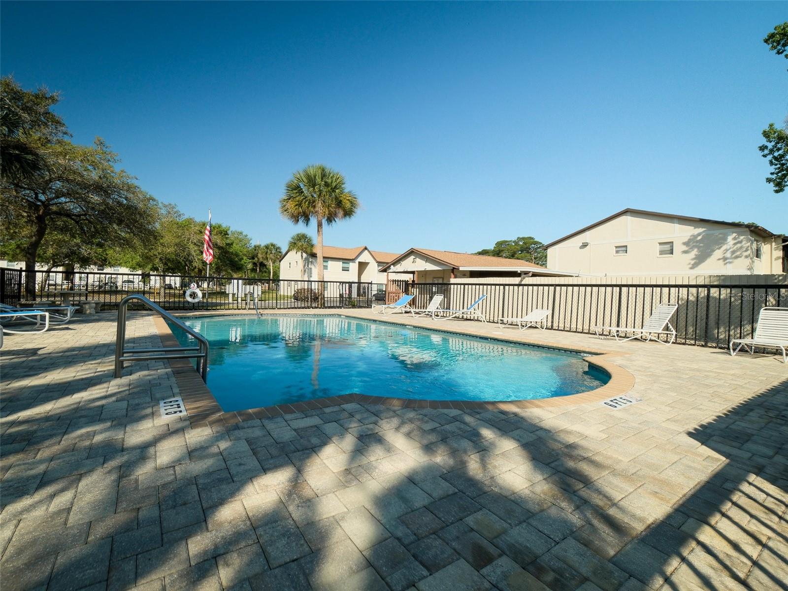 SELLER IS MOTIVATED! Bring all offers to this beautifully maintained first-floor, 2-bedroom, 2-bath condominium located 1 block from the Halifax River and 10 minutes from the beach. This is 922 square feet of comfortable, single-level living designed for simplicity and peace of mind. Step inside to discover a meticulously maintained residence filled with natural light from abundant windows, offering peaceful views of the best corner section of the entire complex. Private and serene, with a perfect blend of nature and the shimmering community pool just steps away, you will feel life in Florida was well worth the prior years of shoveling snow up north. The open floor layout connects the living, dining, and kitchen areas for easy entertaining or quiet evenings at home. The perfectly appointed kitchen has plenty of cupboards and workspace, plus the washer & dryer, ensuring convenience and practicality. The breakfast bar overlooks the living room, and the adjacent formal dining room can also serve as a home office or second living area. The spacious guestroom and hallway guest bath offer ample privacy with plenty of closet space. The master bedroom en suite is everything you would expect in a quality home like this, including a recently remodeled master bath with a modern walk-in shower and vanity.  Many of the furnishings are negotiable, and with this excellent value, low monthly association fee, and peace-of-mind lifestyle, this gorgeous condo is waiting just for you to be its next owner. Centrally situated, you'll love the choices of waterfront dining, fresh seafood spots, marinas, boutique shopping, and entertainment, plus you'll marvel at how the year-round coastal events close by create that small-town charm people dream about when they picture life in Florida. Whether you're searching for a full-time home, seasonal escape, or a low-maintenance lock-and-leave retreat, this condo offers more than just a place to live -- it offers a lifestyle to love.