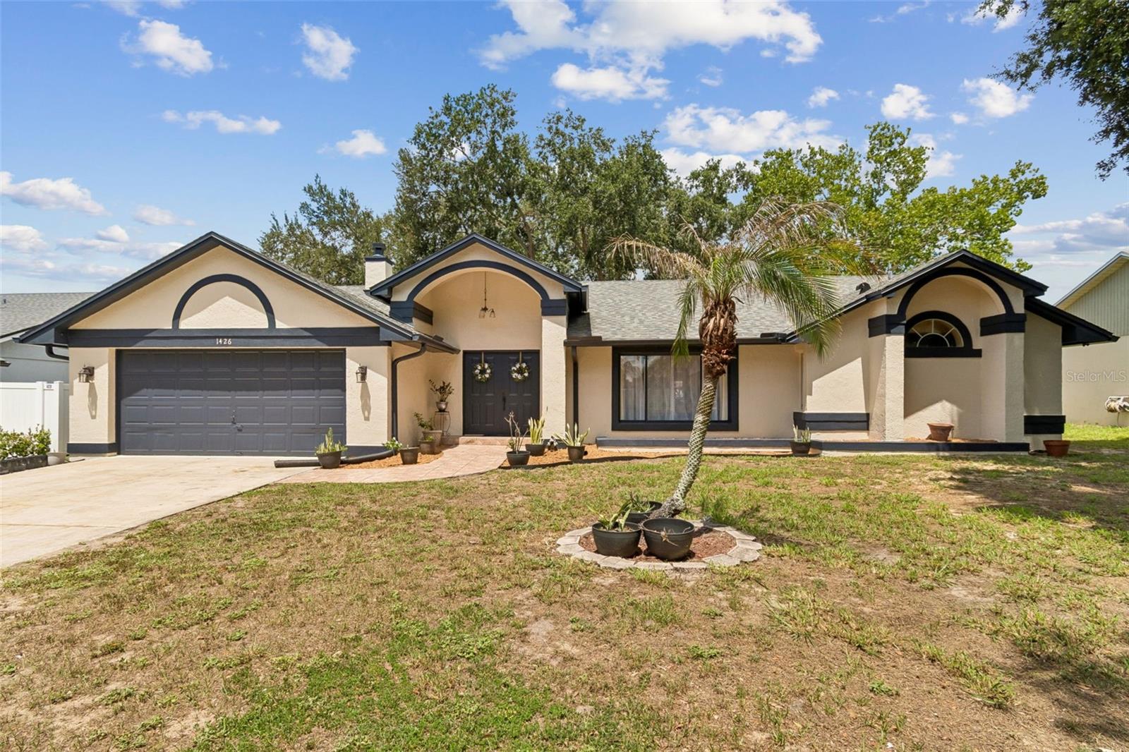 Welcome to a rare opportunity to own a stunning multigenerational home in Orlando!  The IN LAW SUITE is ideal for accommodating your parents or inlaws, older children, extended family, or for hosting long-term guests, or renting for additional income. The beautifully designed main residence features three bedrooms, two bathrooms, and a seamless blend of formal and casual spaces. At the heart of the home is a recently upgraded modern kitchen boasting premium quartz countertops and a bright breakfast nook that flows effortlessly into a cozy family room centered around a wood-burning fireplace. For formal entertaining, the home offers elegant, dedicated living and dining rooms. The expansive primary retreat serves as a true sanctuary, complete with a large closet and a spa-like ensuite bath featuring both a walk-in shower and a deep soaking tub.

Beyond the main living quarters, the property features an in-law suite with its own separate private entrance, offering total independence under one roof. This exceptional wing includes a fully equipped kitchen, a comfortable bedroom, a spacious living room, a full bathroom, and a versatile flex room perfect for a home gym, hobby space, or private office. 

The indoor living transitions beautifully to the outdoors through a large screened-in lanai, which overlooks a massive, fully fenced backyard that offers plenty of room to build your dream pool. Homes with this level of versatility, modern updates, and true independent living quarters rarely hit the market. Don't miss this unique opportunity—schedule your private tour today!