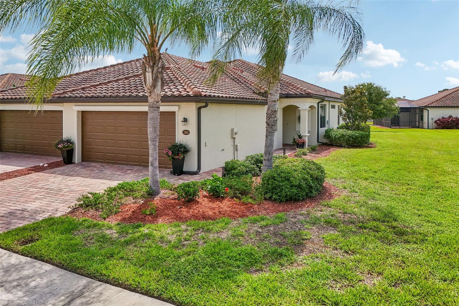 Your vacation doesn't have to end!  This 2 BR & Den, 2 BA, 2-car garage maintenance-free villa is located in the resort-style community "Gran Paradiso at Wellen Park" and situated on a premium lake-view homesite. From the moment you step into this freshly painted and meticulously maintained home, you will be impressed by the soothing neutral color palette and luxury finishes, such as 18" tile on the diagonal, crown molding, custom lighting and fans throughout.  Flooring in the bedrooms and den has been upgraded to plank-style luxury vinyl (no carpet in the entire home!).  The open floor plan is ideal for entertaining or quiet relaxation. Enjoy your morning coffee at the breakfast bar, overlooking your kitchen with 42" wood cabinets, customized pull-out drawers, granite countertops & GE stainless-steel appliances. The office/den is bright & spacious and could easily double as a 3rd bedroom. The split floor plan with guest bedroom and guest bath is perfect when family and friends come to visit. Your Primary Bedroom Suite has sliding glass doors to your lanai and your En Suite Primary bath offers a double vanity, a garden tub and a separate walk-in shower. Upgraded landscaping and landscape lighting, an inside laundry room, a spacious 2-car garage and subflooring in the attic complete this beautiful home. HOA fees include the use of all the community amenities, lawn care, irrigation, fertilization, mulch, basic cable & high-speed internet, roof repair & replacement and periodic exterior painting.  Gran Paradiso is an amenities-rich, maintenance-free resort community, situated in the vibrant Wellen Park area. Rivaling a vacation resort, owners enjoy a beach-entry pool, Tuscan-inspired Clubhouse, game rooms, tennis, pickle ball, state-of-the-art fitness center, sauna/steam rooms & massage rooms. There is a myriad of activities for the residents, organized by a full-time Lifestyle Director. Gran Paradiso is golf-cart friendly and encompasses over 1,000 acres with extensive walking and biking paths. Wellen Park offers a marketplace with a variety of shopping and restaurants and the Spring Training Stadium of the Atlanta Braves, the 2021 World Series Champions. There is also an 80-acre lake, surrounded by bike paths and lake-front eateries. The amazing Gulf beaches and quaint downtown Venice are only 15 min away.  Schedule your showing today!