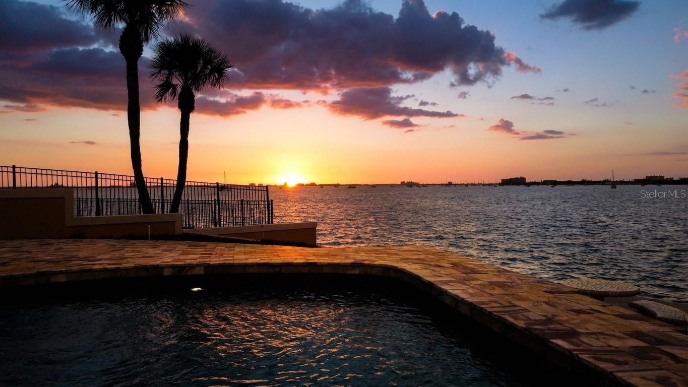 One or more photo(s) has been virtually staged. Exceptional Open-Water Estate | 160 Ft of Prime Waterfront in Broadwater

Experience elevated coastal living in this rare open-water residence located in the highly desired Broadwater boating community. Positioned at the end of a quiet cul-de-sac on an expansive 0.41-acre pie-shaped lot, this exceptional property offers 160 feet of direct Boca Ciega Bay frontage with breathtaking 270° panoramic views and quick access to the Gulf of Mexico.

This elevated, no-flood-history home features 4 bedrooms, 3 bathrooms, and over 3,900 sq ft of living space thoughtfully designed to capture water views from nearly every room while maintaining privacy. A desirable 3-way split floor plan offers multiple living and entertaining areas, including formal living and dining rooms.

The light-filled family room impresses with 13-foot vaulted ceilings, a wood-burning fireplace, and walls of floor-to-ceiling windows framing spectacular open water views. Interior finishes include polished marble flooring, custom built-ins with wine storage, and a timeless neutral palette.
At the heart of the home, a spacious gourmet kitchen features a large center island beneath a skylight, decorative ceilings, crystal lighting, expansive granite countertops, multiple sinks, stainless steel appliances, and a sunlit breakfast nook.
The waterfront primary suite offers stunning views, a walk-in closet, and a spacious ensuite bath. Additional highlights include a luxurious marble guest bath with jetted tub and a convenient pool bath with outdoor shower.
Step outside to your private waterfront retreat featuring a 34’ x 16’ pool, imported natural onyx paver decking, and an impressive 900 sq ft waterfront landing—ideal for entertaining, relaxing, or enjoying unforgettable sunsets. Prior dock and lift permits remain on record, allowing for a streamlined process to rebuild your private dock along the 160 ft seawall.
Recent updates include a brand-new 2025 concrete tile roof, updated systems, refreshed interiors, and more—making this home truly move-in ready.
Enjoy daily dolphin sightings, vibrant sunsets, and front-row views of holiday boat parades—all just minutes from Downtown St. Petersburg, world-class dining, museums, beaches, and major airports.
A rare opportunity to own one of St. Petersburg’s most spectacular open-water properties.

One or more photo(s) has been virtually staged.