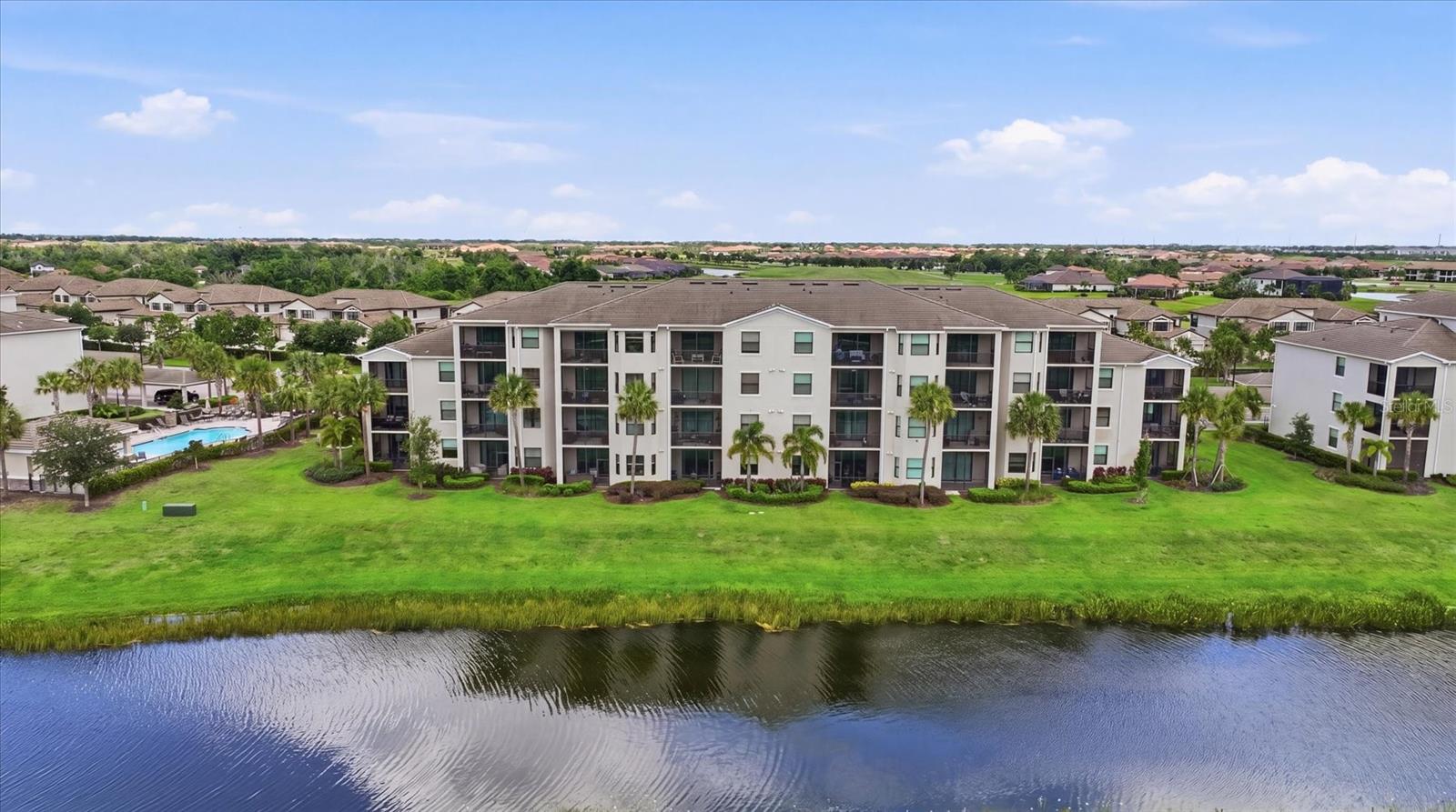 Luxury Living & Effortless Resort Lifestyle in a Premier Golf & Sports Community

Welcome to your ultimate stress-free Florida retreat! Located on the second floor and just a short stroll from the elevator, this stunning, turnkey-furnished condominium offers the perfect blend of modern luxury, convenience, and unparalleled recreation. Step inside to find a beautifully appointed interior featuring high-end, brand-name furniture, custom closets by Closet Tec, and beautifully upgraded light fixtures and ceiling fans throughout. Every detail has been curated so you can move right in and start living the resort lifestyle on day one.
This spacious 2-bedroom, 2-bathroom unit boasts an open-concept floor plan that flows seamlessly out to a private balcony. From there, you will enjoy breathtaking views overlooking the 15th fairway of the Arnold Palmer-designed Piper Course, tranquil water, and a densely wooded, protected wildlife area. Positioned to give you the best of both worlds, this home is incredibly close to all of the club’s world-class amenities while still providing supreme solitude from inside the home. For added convenience, this unit includes a dedicated parking spot right out front and the largest outside storage unit in the entire building.  Adding to the true “lock-and-leave lifestyle”, for those who won’t be full-time, the apartment has hurricane-proof windows and a hurricane proof slider door!

Lakewood National is a golfer’s paradise situated within a spectacular 900+ acre gated community. Your lifestyle package includes bundled equity golf membership with access to two 18-hole Arnold Palmer-designed championship courses. Serious players and casual golfers alike will thrive using the massive, top-tier practice facilities, which feature an expansive driving range, dedicated chipping & pitching areas, practice bunkers, and a sprawling putting green.  The Lakewood National Commander course is the host venue for the Korn Ferry Tour’s annual LECOM Suncoast Classic.

Beyond the greens, residents enjoy a vibrant, active atmosphere with access to:
• Racquet Sports: Championship tennis courts and pickleball courts.
• Wellness & Fitness: State-of-the-art fitness center and full-service spa.
• Pools & Socializing: Resort-style swimming pools and the famous Lakewood National Tiki Bar, complete with a full restaurant, bar and grill -- which includes all day lunch, drinks, dinner, and of course an after golf, tennis or pickle center of social life at LWNGC.

• Clubhouse: An elegant main clubhouse perfect for dining and community events.
Conveniently situated near premier shopping, dining, and entertainment, this condominium offers both high-end luxury and absolute convenience. 

Don’t miss your opportunity to experience effortless, maintenance-free resort living every single day!