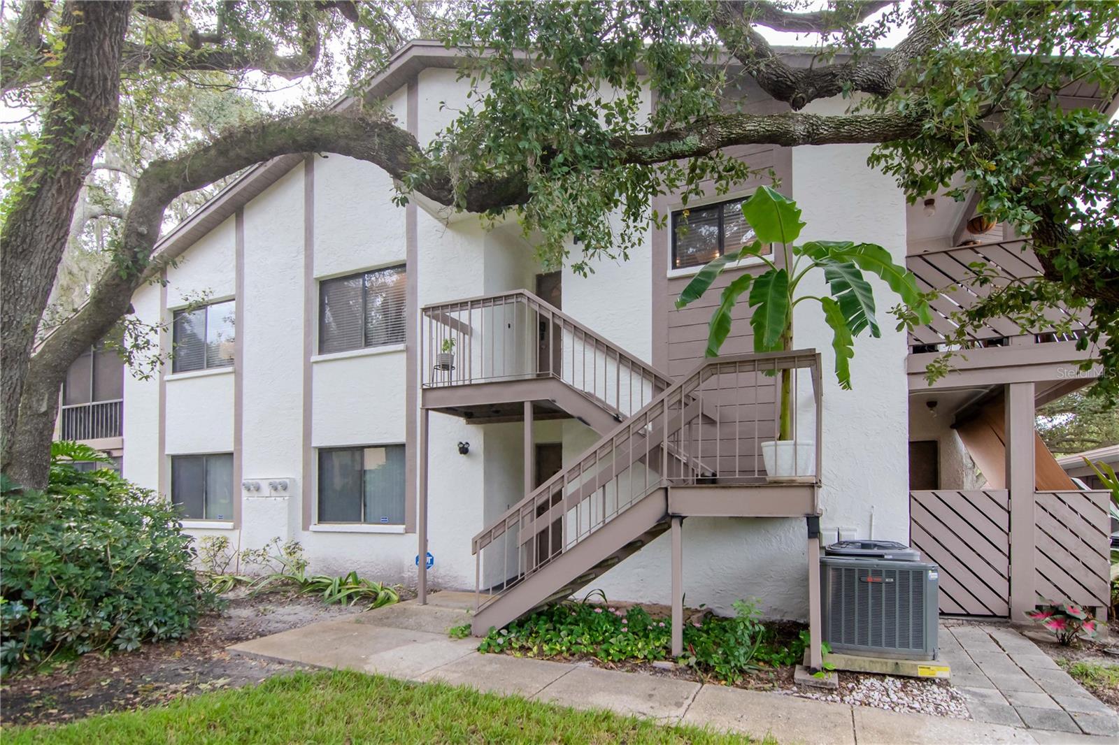 Major Price Improvement! Discover this beautifully updated 3-bedroom, 2-bathroom condo located in the highly sought-after Yorktown at Beacon Place community in Safety Harbor. This spacious second-floor unit features an open floor plan with abundant natural light, a large living and dining area, and a fully renovated kitchen with shaker cabinets, granite countertops, and stainless steel appliances. The split-bedroom layout offers privacy, with a generous primary suite that includes a walk-in closet and updated en-suite bath. The two additional bedrooms are ideal for guests, a home office, or hobbies, and the second full bathroom has also been tastefully renovated.
Enjoy two private patios with new hurricane rated sliding glass doors—one in front with an exterior storage closet and one in the rear, perfect for relaxing or entertaining. The in-unit laundry room adds convenience, and a covered carport with additional private storage is included. The building is directly across from the community pool and clubhouse. The monthly condo fee includes cable, internet, water, sewer, trash, exterior maintenance, and more. Located just minutes from downtown Safety Harbor, shopping, dining, parks, and the waterfront.