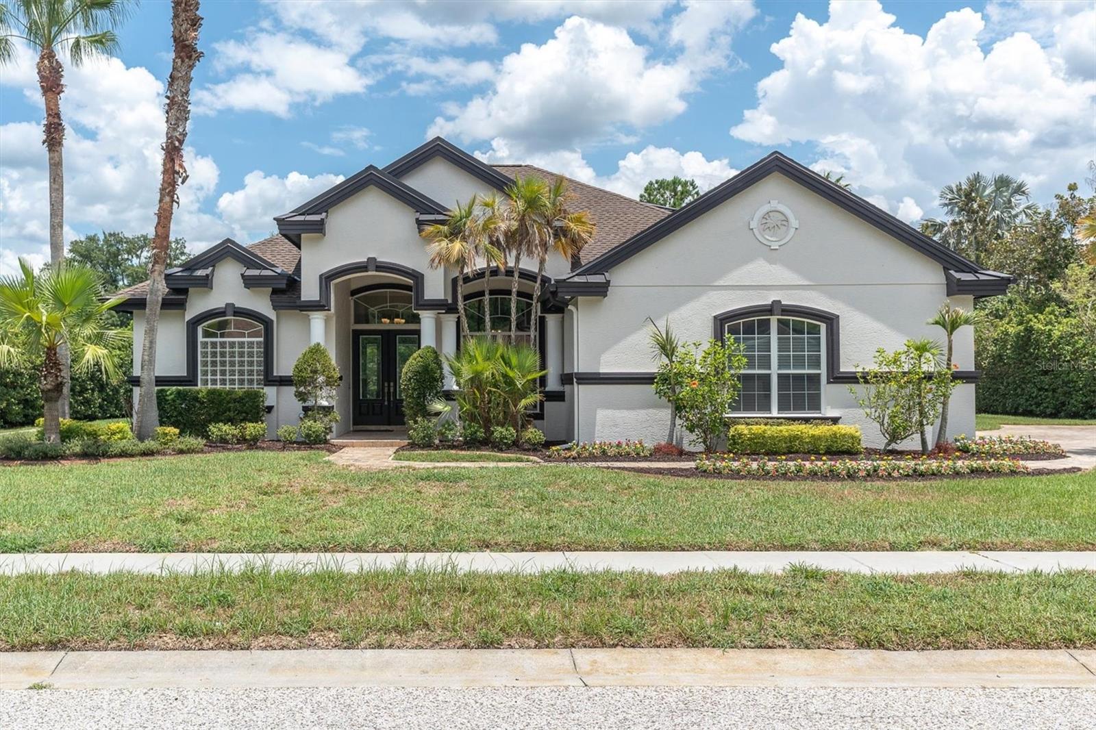 Virtually Staged. Rarely does a home in Grey Hawk at Lake Polo offer this combination of land, water, lifestyle, and move-in-ready design. Perfectly positioned on an oversized half-acre homesite with peaceful pond views, this freshly renewed Odessa residence delivers the space, privacy, and elevated Florida living buyers are searching for, all within a gated community and sought-after school area.

Outdoors, this home truly separates itself. The screened pavered lanai features a private pool and heated spa, two generous covered entertaining spaces, and an outdoor kitchen designed for year-round Florida living. Beyond the lanai, the backyard opens to an expansive lawn with a paver fire pit area and tranquil water views, creating a setting that feels private, usable, and difficult to duplicate at this price point.

From the moment you arrive, the curb appeal feels polished and inviting with fresh exterior paint, a new roof, lush landscaping, a paver drive, and a side-entry 3-car garage with oversized parking, golf cart parking, and EV charging. Inside, the home has been beautifully updated with fresh interior paint, new luxury vinyl flooring, new carpet, and a clean, current palette that makes every room feel bright, calm, and ready.

The floor plan is exceptionally versatile, offering 4 bedrooms, 4 full bathrooms, a dedicated office, formal and casual living spaces, an expansive upstairs loft with a full bathroom, and an additional bonus room that creates a true surprise space. Whether used as a media room, game room, teen retreat, fitness area, homeschool space, guest lounge, or second office, this home adapts beautifully to the way people live today.

The main living areas are open and spacious with high ceilings, abundant natural light, and seamless views to the screened outdoor living area. At the heart of the home, the refreshed kitchen brings timeless style and everyday function together with stone countertops, solid wood cabinetry, soft-close upgraded cabinet features, built-in oven, cooktop, range hood, generous prep space, and a natural connection to the great room and dining areas.

The main-floor primary suite offers a peaceful retreat with a glass slider overlooking the resort-style lanai, pool, spa, and pond beyond. Dual walk-in closets add everyday luxury, while the spacious bath features dual vanities, soaking tub, private water closet, linen storage, and walk-in shower.

Grey Hawk at Lake Polo offers a gated setting with private roads, park, playground, dog park, sidewalks, golf carts permitted, and community lake access with dock/fishing amenities. With a Flood Zone X designation, no reported damage from the 2024 storms, no CDD, and a convenient Odessa location near Trinity, Tampa, top schools, shopping, dining, and the Veterans/Suncoast Expressway, this home delivers the lifestyle buyers wait for.

For 3D walkthrough and more, copy and paste: bit.ly/1526LakePolo

Fresh, spacious, beautifully updated, and set on one of the most compelling homesites in the community — this is the one to see now.
