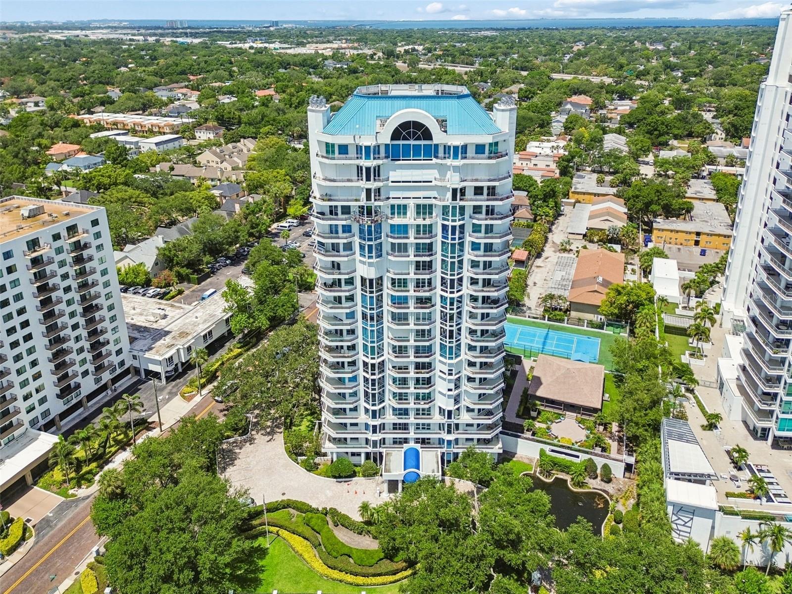 Wake up to breathtaking sunrises over the Bay and unwind each evening with spectacular sunsets over Tampa! This amazing condo offers both stunning 180-degree views from the comfort of this exceptional residence at Bayshore Regency. One of Tampa’s most prestigious waterfront addresses, Unit 1401 was completely renovated in 2020 and offers sophisticated modern luxury, exceptional craftsmanship, and panoramic views from nearly every room. Every detail of this residence has been thoughtfully curated, from the reimagined chef’s kitchen featuring custom Kraft Maid cabinetry and elegant travertine flooring throughout, to the seamless open-concept design ideal for both everyday living and entertaining. The kitchen is appointed with premium appliances, including a double-door Sub-Zero refrigerator, Wolf double ovens, and a sleek black glass Wolf electric cooktop. A large center island provides abundant storage, while the spacious walk-in pantry offers added convenience.Flowing effortlessly into the dining and living areas, the expansive living space is framed by floor-to-ceiling windows that showcase sweeping views of the Bay and downtown Tampa. The adjacent bar area features a glass-front Sub-Zero beverage center and ice maker, creating the perfect setting for entertaining. Multiple sliding glass doors fill the living room with natural light, while recessed lighting and a built-in electric fireplace with customizable color-changing flames add warmth and ambiance.A private elevator entrance welcomes you into a grand foyer highlighted by a custom etched-glass door and elegant coffered ceiling. The luxurious primary suite offers a private balcony, two custom-designed walk-in closets, and a spa-inspired bathroom featuring a stunning marble shower. The secondary bedroom provides exceptional privacy, beautiful views, and automatic Hunter Douglas window treatments. With only two residences per floor, Bayshore Regency offers an unparalleled level of privacy and exclusivity, combining luxury living with some of the most remarkable waterfront views in Tampa. Enjoy 5 balconies with breathtaking day/night views—greenery, oak trees, lit bridges, and downtown. Steps from iconic Bayshore Boulevard’s endless sidewalk for scenic walks. Includes 2 contiguous private parking spaces near elevator, private storage. Amenities include an equipped gym, billiards/ping-pong, clubhouse with kitchen and decks, tennis/pickleball, pool/spa, and sundeck. On-site management keeps this well-maintained building pristine. The ultimate in refined Florida living!