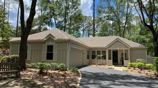 Now available for rent in desirable Haile Plantation! This charming 3-bedroom, 2-bath home features a side-entry 2-car garage and a thoughtfully designed split-bedroom floor plan.

The spacious kitchen offers abundant cabinet storage, stainless steel appliances, solid-surface countertops, and a dining area perfect for everyday meals or entertaining. The inviting living room features a wood-burning fireplace and skylights that fill the space with natural light.

The private primary suite includes a walk-in closet and en-suite bath. A versatile bonus room off the living area, complete with closets, can serve as a home office, guest room, or additional bedroom.
Enjoy Florida living year-round on the covered, screened patio, which opens to a large backyard deck—ideal for relaxing or entertaining. A washer and dryer are conveniently located in the garage.