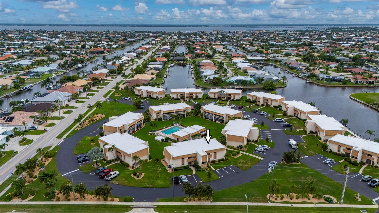 Turnkey coastal comfort in the heart of Punta Gorda Isles. This fully furnished 2-bedroom, 2-bath second-floor condo at Islander Point offers an easy, low-maintenance lifestyle in one of PGI’s waterfront communities. Inside, you’ll find a bright great room layout, split-bedroom floor plan, updated flooring, cheerful coastal furnishings, and a practical kitchen with breakfast bar. The screened lanai backs up to the pool area, creating a relaxing spot to enjoy morning coffee, afternoon breezes, or the community’s tropical setting. Islander Point offers a heated community pool, mature landscaping, assigned parking, guest parking, and a wraparound concrete dock with quick boating access to Charlotte Harbor. Dock space is available on a first-come, first-served basis and was available at time of listing. The association is pet friendly, allowing owners to enjoy the Punta Gorda lifestyle with their four-legged companions. Miles of sidewalks connect you to parks, St. Andrews South Golf Club, Isles Yacht Club, Fishermen’s Village, the Harborwalk, and historic downtown Punta Gorda. With furnishings in place, boating access(up to 26 feet in length), and the pool just beyond your lanai, this condo makes it easy to settle in and start enjoying Southwest Florida from day one.