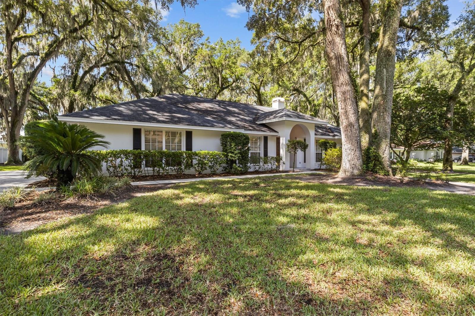 Nestled beneath a canopy of majestic oak trees on nearly half an acre, this beautifully maintained South Lakeland home offers the perfect blend of space, privacy, and location. Tucked away in the highly sought-after Longwood Oaks community, this property welcomes you with mature landscaping, timeless curb appeal, and the peaceful feeling of a neighborhood where homes rarely become available.Step inside and imagine gathering with family and friends around the cozy wood-burning fireplace, enjoying holiday celebrations in the spacious living areas, or simply relaxing after a long day while taking in views of the lush backyard. Natural light fills the home, creating a warm and inviting atmosphere throughout.Thoughtful updates provide peace of mind and convenience, including new screens, new exterior doors leading to the patio from the bedroom and bathroom, a new exterior garage door, a new refrigerator, and a commercial-grade Speed Queen washer and dryer. Outside, new ceiling fans on the screened patio create the perfect setting for year-round outdoor living and entertaining.The oversized lot provides room to spread out, garden, entertain, or simply enjoy the beauty and shade of the mature oak trees that make this property feel like a private retreat. Whether you're sipping your morning coffee or unwinding in the evening, the screened patio offers a peaceful connection to the outdoors.Location is everything, and this home delivers. Situated in one of Lakeland's most desirable areas, you'll enjoy convenient access to Lakeland Highlands, the Polk Parkway, Lakeside Village, top-rated schools, shopping, dining, and medical facilities while still enjoying the quiet charm of an established neighborhood.If you've been searching for a home with character, space, mature trees, and an unbeatable South Lakeland location, 1142 Longwood Oaks Boulevard is a rare opportunity you won't want to miss. Schedule your private showing today and discover why homes in Longwood Oaks are so highly sought after.