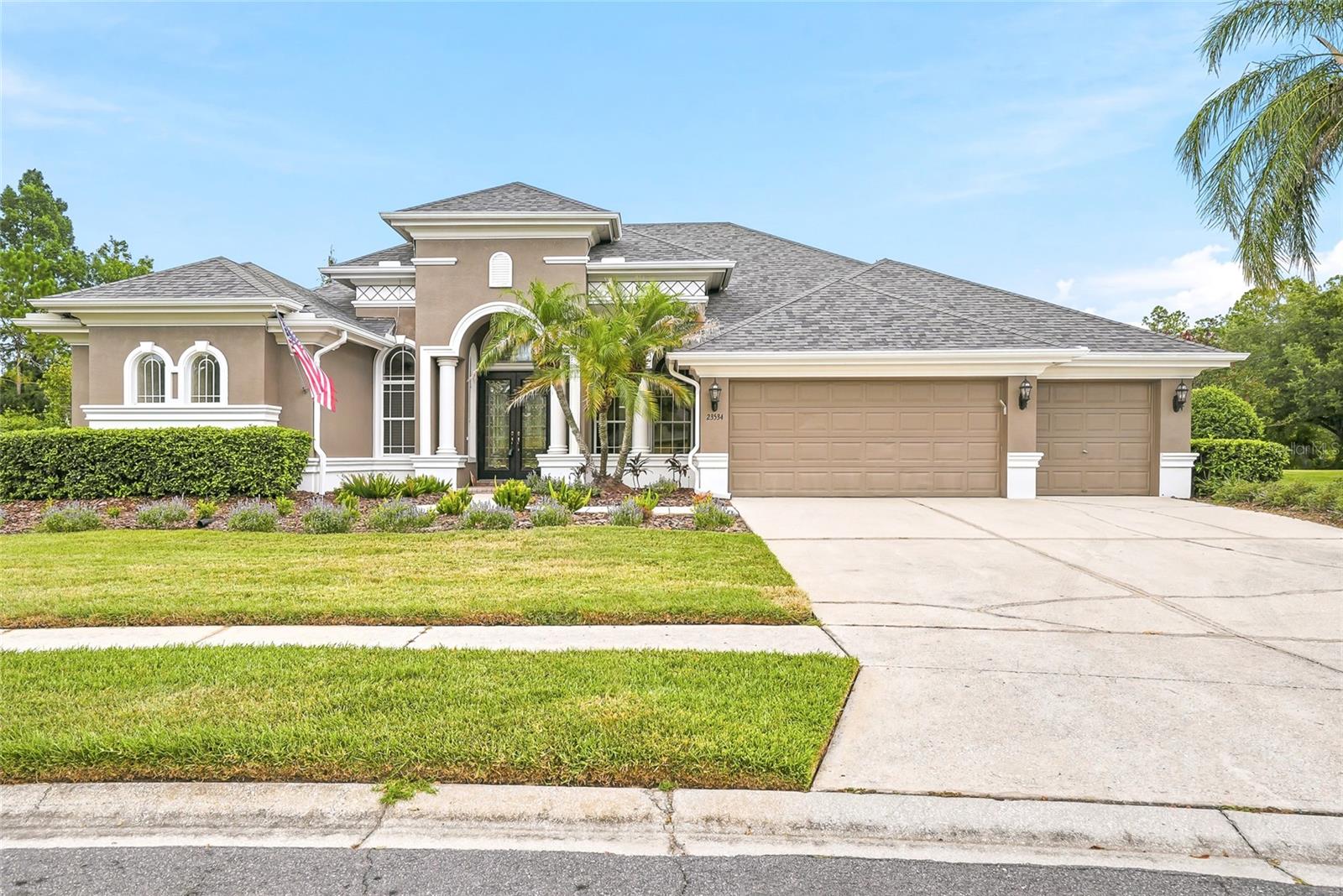 Welcome to an exceptional home in the exclusive gated community of Savanna, a private enclave within Plantation Palms. Perfectly positioned on an oversized homesite overlooking both the golf course and conservation, this beautifully updated residence offers nearly 3,500 square feet of thoughtfully designed living space with a highly desirable three-way split floor plan. Featuring 4 bedrooms, 4 full bathrooms, a dedicated office, conservatory, and expansive bonus room, this home provides the ideal balance of comfort, privacy, and functionality. The stunning remodeled kitchen serves as the heart of the home, showcasing modern finishes, abundant cabinetry, and under-cabinet lighting that creates a warm and inviting atmosphere for everyday living and entertaining. Designed for both relaxation and entertainment, the spacious bonus room is equipped with a 130-inch projector screen and surround sound system, creating the ultimate home theater experience. The open layout flows seamlessly to the outdoor living area, where you'll find a screened lanai, sparkling pool and spa, and a fully equipped outdoor kitchen perfect for enjoying Florida living year-round. Additional highlights include a 3-car garage, modern upgrades throughout, generous living spaces, and breathtaking views that combine the beauty of nature with the manicured fairways of Plantation Palms Golf Club. Conveniently located just minutes from Tampa Premium Outlets, the Land O' Lakes Recreation Complex, top-rated schools, restaurants, shopping, and major commuter routes, this remarkable property offers the perfect combination of luxury, location, and lifestyle. Experience refined Florida living in one of Land O' Lakes' most sought-after gated communities. This is a home you won't want to miss.