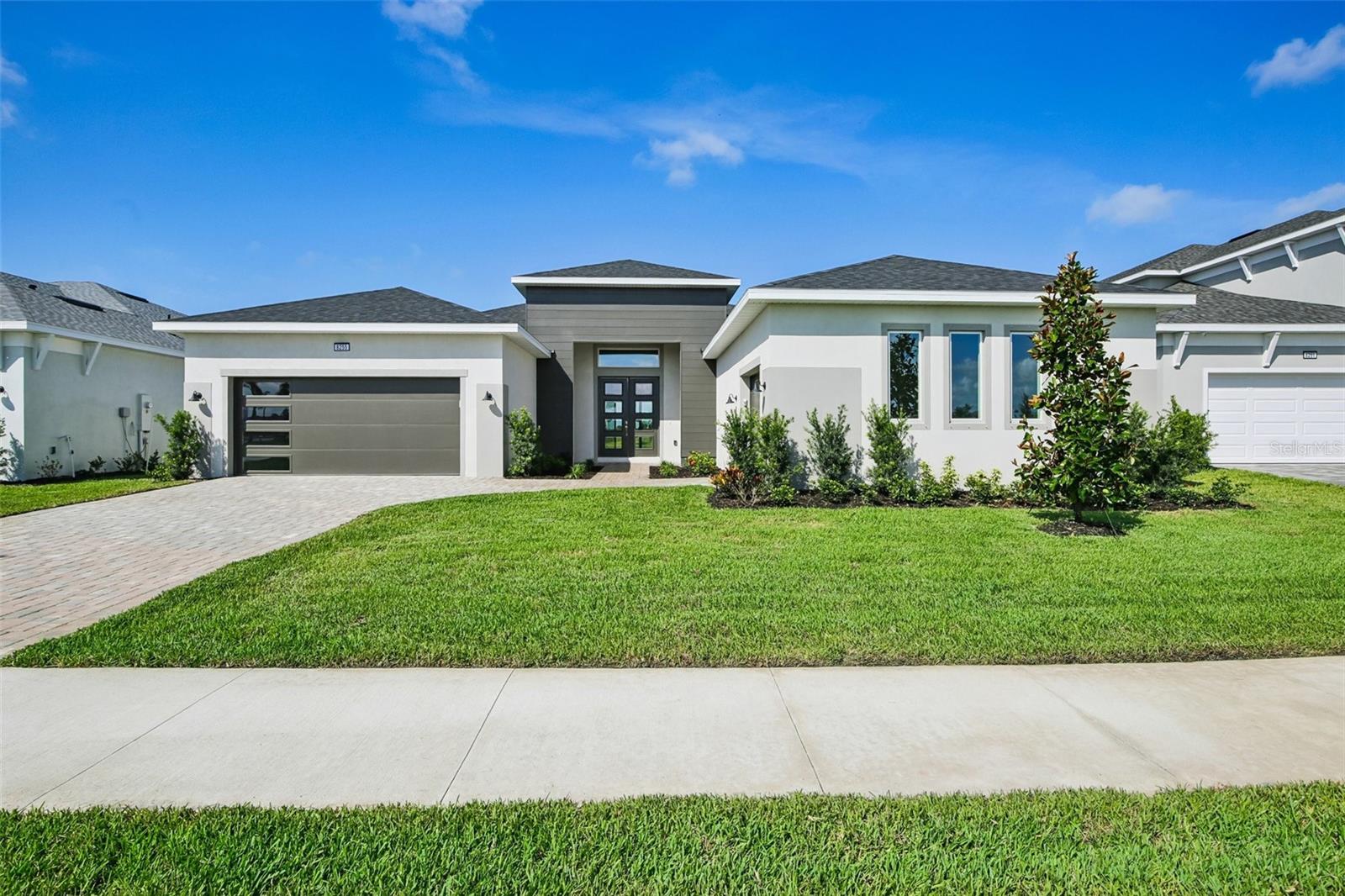 Welcome to 8255 Golden Beach Court in Parrish, FL, a beautifully designed one-story Sabal home in the desirable Seaire master-planned community. This modern residence combines elegance with functionality, offering scenic wetland views from the covered lanai in the backyard—ideal for unwinding or hosting gatherings. Inside, you’ll discover a thoughtfully designed space with tile flooring throughout the living room and kitchen. The kitchen shines with gray cabinets and granite countertops, creating a sleek and functional heart of the home. The dining room is brightened by an upgraded window package, allowing natural light to flood the area. The primary bedroom suite features an upgraded window package for added brightness and privacy, while the primary bathroom exudes luxury with floor-to-ceiling tile in the shower and quartz countertops paired with upgraded cabinetry. Additional living spaces include two secondary bedrooms, a dedicated office for productivity or remote work, and a bonus family room for extra entertainment or recreation. The home also offers ample storage and convenience with a three-car garage, making it perfect for modern living in a vibrant community.