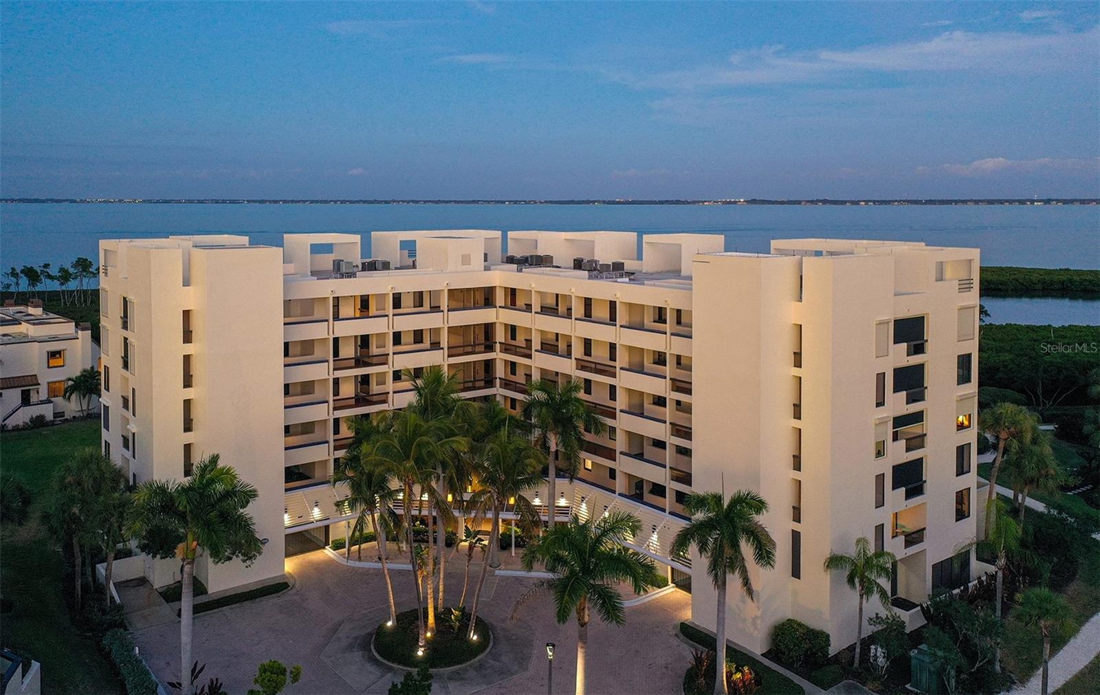Value opportunity behind the gates of Bay Isles in the highly sought after Fairway Bay community. This turnkey furnished move-in ready two-bedroom, two-bathroom residence presents an exceptional chance to enjoy the Longboat Key lifestyle along with the rare advantage of one under building garage parking space. Enjoy peaceful views of Sarasota Bay, surrounding mangroves, and native wildlife from an open floor plan designed to maximize natural light and comfortable indoor and outdoor living. White tile flooring runs throughout the main living areas, while a wall of sliding glass doors opens to the terrace, ideal for relaxing outdoor eating. The kitchen features light cabinetry, custom lighting and captures water views. The primary suite offers direct terrace access and an ensuite bath with dual vanities, upgraded shower, and a fitted walk-in closet. A welcoming guest bedroom has an ensuite bath with upgraded spa tub. Ready for immediate enjoyment as a primary home, seasonal retreat, or investment opportunity. Ownership includes membership to the private Bay Isles Beach Club with deeded beach access and facilities for social activities. Residents of Fairway Bay enjoy walking trails, heated pools, a fitness center, tennis and pickleball courts, clubhouse amenities, and kayak launches. Optional membership to the Longboat Key Club provides access to championship golf, Har Tru tennis, spa services, waterfront dining, and a deep-water marina. Ideally located just minutes from St. Armands Circle and downtown Sarasota’s renowned arts and dining scene, this residence offers comfort, convenience, and an outstanding opportunity to enjoy the Longboat Key waterfront lifestyle within one of the island’s most desirable gated communities.