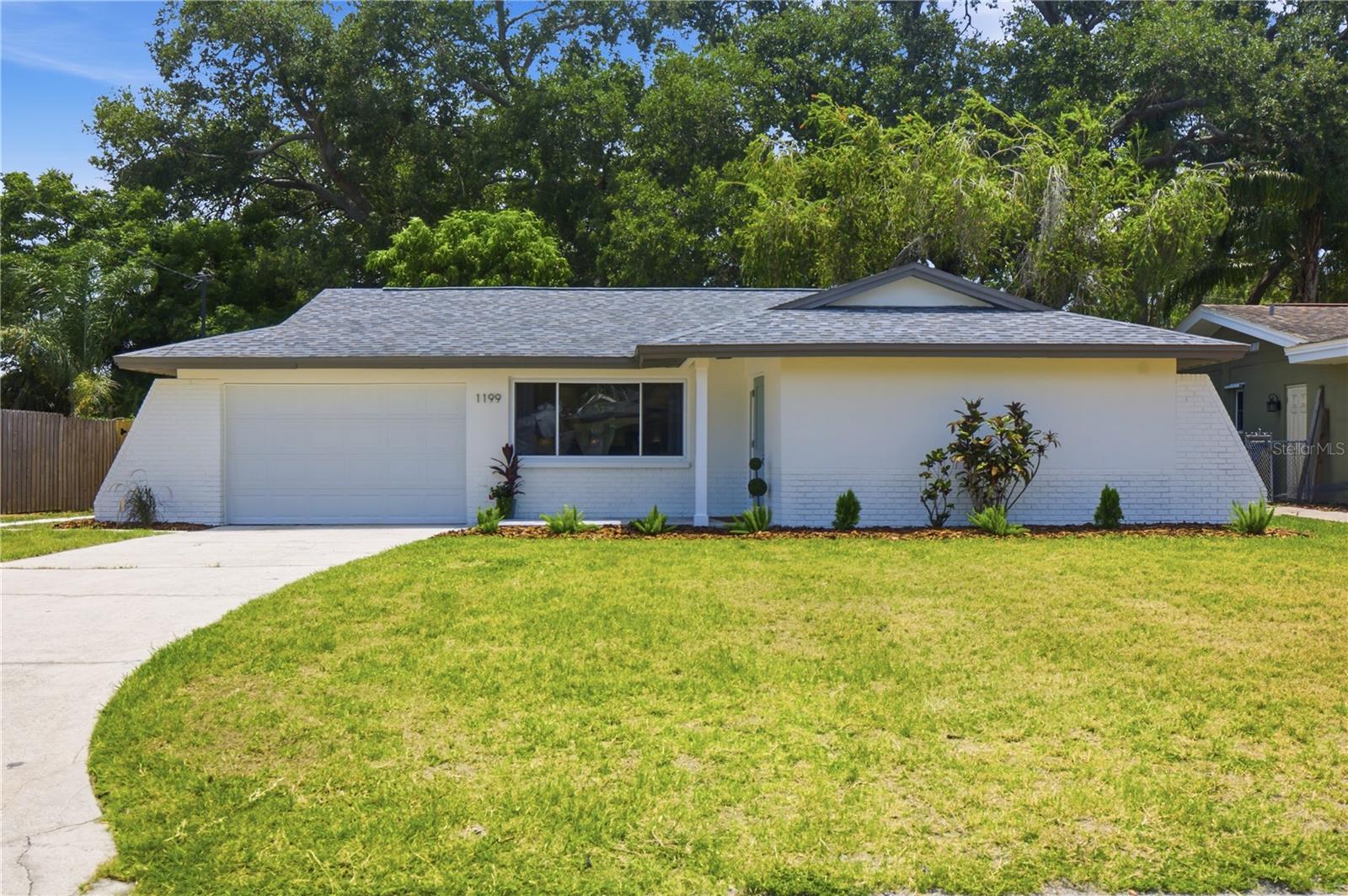 Golf Cart to Downtown Dunedin!!  Beautifully Remodeled 2-Bedroom, 2-Bath Home! This two-bedroom, two-bath home with large 1.5-car garage is perfectly located just minutes from Downtown Dunedin, the Pinellas Trail, and Honeymoon Island. Completely remodeled inside and out, it features new hurricane impact rated windows and sliding glass door, along with all new exterior doors. The brand-new kitchen shines with quartz countertops, 36" shaker cabinets with crown molding, champagne bronze accents, stainless steel appliances, and recessed lighting. Both bathrooms have been thoughtfully renovated. As you step outside you are greeted with a relaxing screened-in porch to start your mornings with your coffee or unwind in the evenings while catching the breeze in your fenced-in, completely private, and shaded backyard. Additional highlights include new interior and exterior paint, new flooring throughout, and an open, light-filled layout ideal for entertaining. Experience the ultimate Dunedin lifestyle- bike to the beaches, golf-cart downtown for dinner, or walk/bike to the water to enjoy nightly waterfront sunsets just a short distance from this beautiful, move-in-ready home.