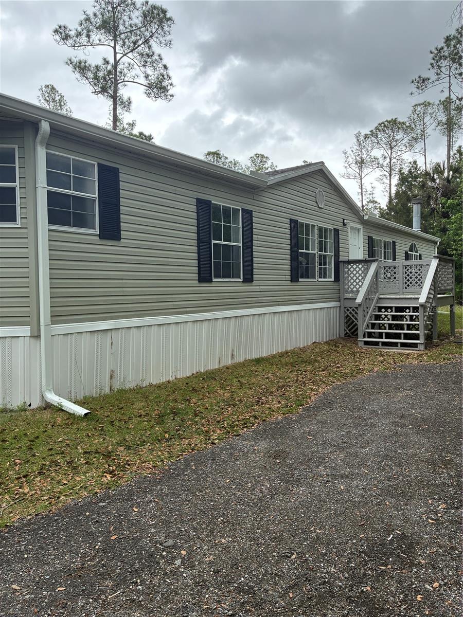 Nestled in the peaceful countryside of Bunnell, this charming mobile home offers the perfect blend of space, comfort, and outdoor lifestyle. Located just half a mile from Dead Lake, you’ll enjoy direct access to the scenic St. Johns River—a true haven for boating and fishing enthusiasts. MOTIVATED SELLERS!

Exciting new developments are underway nearby, including a waterfront restaurant with float docks, as well as convenient campsite options, adding even more appeal to this already desirable location.

Situated on over 2 acres, this property provides plenty of elbow room for family gatherings, outdoor activities, or simply enjoying the tranquility of nature. Inside, the home features a beautiful fireplace, freshly painted interiors, and updated exterior shutters, giving it a clean and welcoming feel.

The property also includes a newly restored water treatment system, ensuring clean, drinkable water, and a large powered shed in the backyard—perfect for storage, a workshop, or hobby space.

Whether you're looking for a peaceful retreat or a true fisherman’s paradise, this property offers endless possibilities. New Roof 2025!