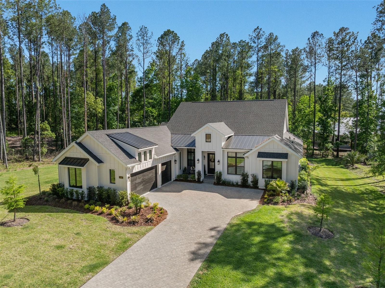 Price Improvement!  Nestled within the gated, resort-style community of Southern Hills Plantation Club, this immaculate single-owner ranch home offers a lifestyle defined by scenic beauty, recreation, and connection. Featuring 4 bedrooms, 5 bathrooms, a spacious bonus/great room, an open-concept kitchen, dining, and living area, plus a separate office or game room, the layout is both functional and inviting. Set on an oversized 0.72-acre homesite—significantly larger than most in the neighborhood—the property enjoys a premier setting with tranquil golf course views from the front and a welcoming front porch designed to take it all in.

Life here centers around the community’s award-winning Pete Dye golf course, elegant clubhouse, resort-style pool, fitness center, tennis and pickleball courts, and a vibrant year-round social calendar. Inside, the home reflects this elevated lifestyle with over $160K in builder upgrades, including soaring vaulted ceilings, custom architectural details, and seamless indoor-outdoor living highlighted by an expansive lanai with dramatic ceiling height, already prepped for a future outdoor kitchen and pool. The designer kitchen features premium GE Café appliances, quartz countertops, custom cabinetry, and luxury finishes, while spa-inspired bathrooms offer floor-to-ceiling tile, a freestanding tub, and upgraded fixtures.

Additional highlights include smart home pre-wiring, in-ceiling speakers, and future-ready upgrades for gas, pool, and AV, providing both convenience and flexibility. A high-ceiling, epoxy-finished garage, striking modern farmhouse exterior, and elevated finishes throughout complete the offering—delivering not just space and style, but a rare opportunity to fully embrace one of Brooksville’s most sought-after lifestyle communities.