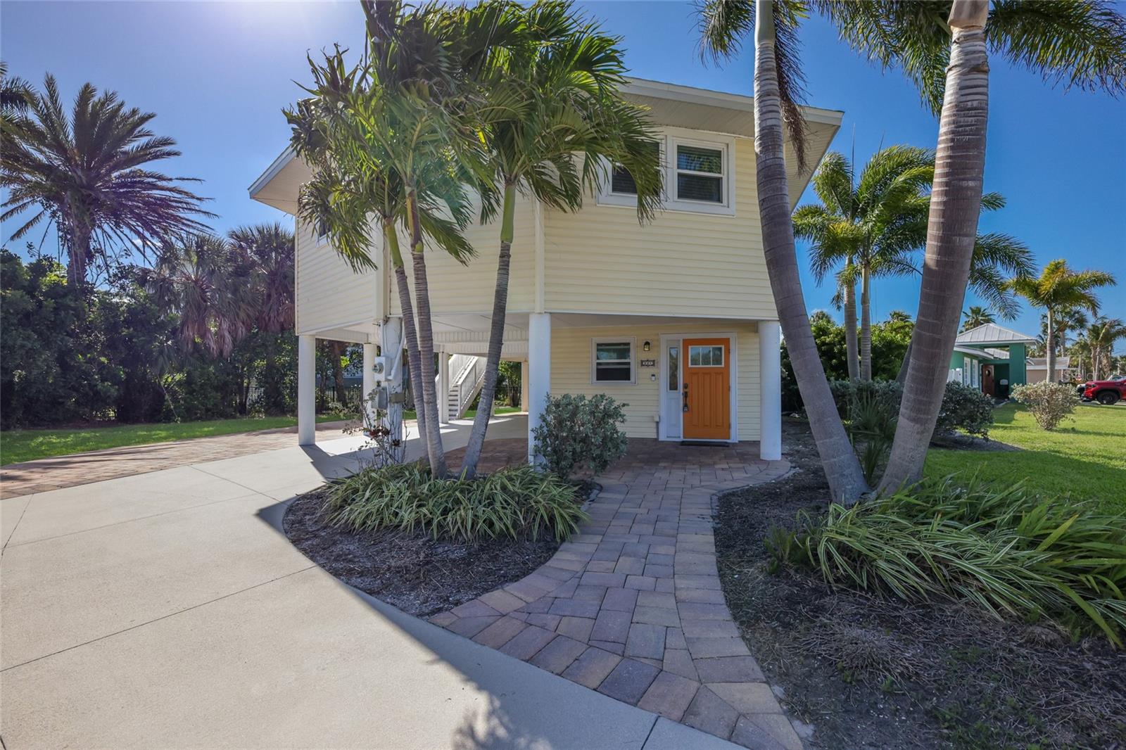Discover the best of island living in beautiful Holmes Beach! Nestled on a quiet street in a peaceful neighborhood, you’ll love the combination of boating access and close proximity to the beach this home has to offer. Elevated with impact windows, this 2-bedroom, 2-bathroom home is  turnkey furnished and includes a deeded, unimproved boat slip at the end of 85th Street, perfect for boating enthusiasts and those seeking the ultimate coastal lifestyle. New roof installed in August 2025. The downstairs area has been professionally remediated and renovated, while the upstairs living area remained untouched by hurricanes in 2024.  Situated on an expansive 9,000sqft lot, there is ample space to add a pool and create your own private oasis. Whether you’re seeking a primary residence or a tropical getaway, this property is ideal for enjoying Anna Maria Island living. Book your showing today!