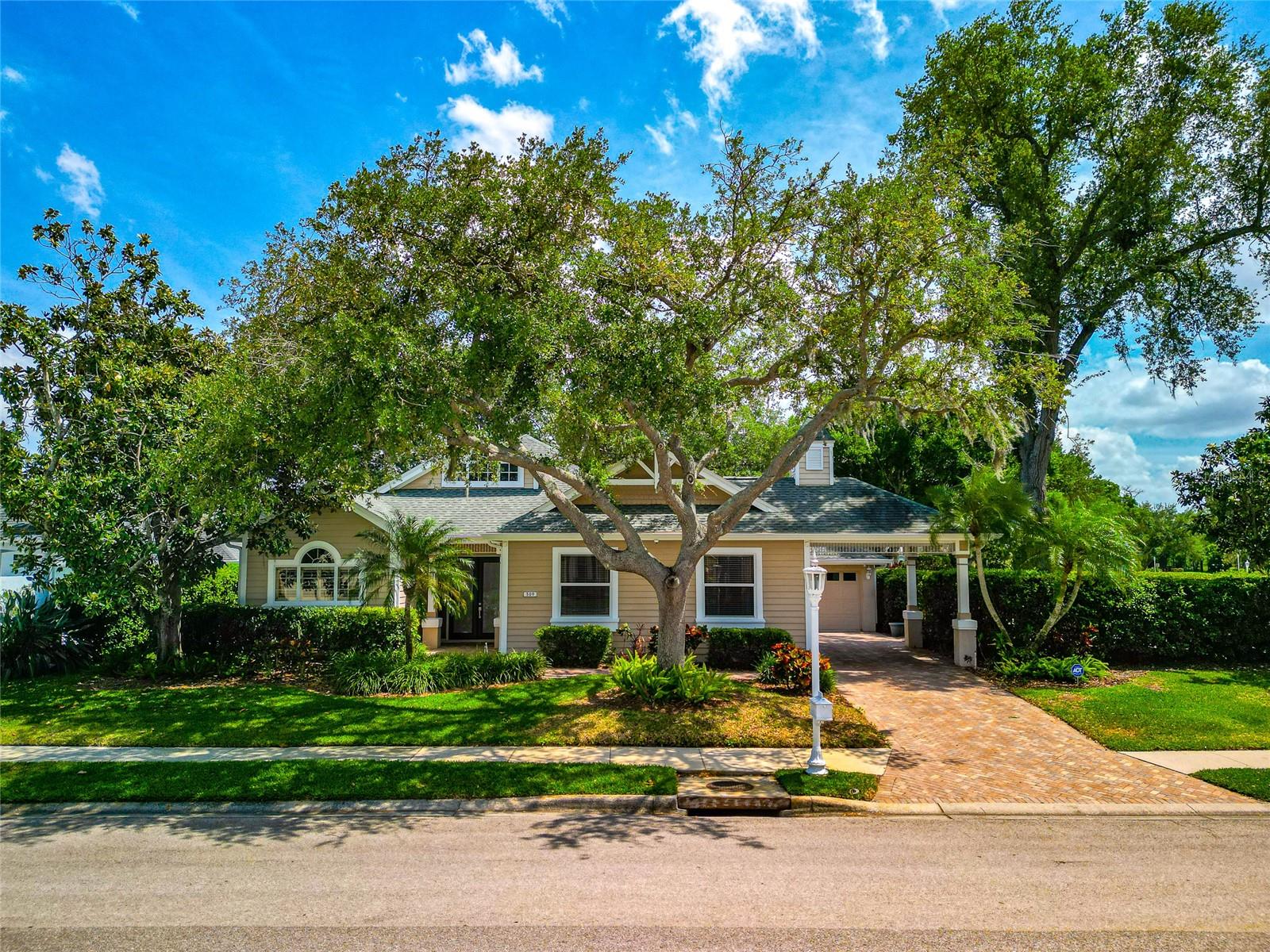 Virtually Staged. Nestled in the highly sought-after boating community of The Inlets at Riverdale, this charming Key West–style Intrepid Model offers coastal elegance. Set along the scenic banks of the Manatee River, The Inlets is known for its idyllic atmosphere, distinctive architecture, gas lanterns, porte-cochères that create a truly unique lifestyle. Situated on an oversized corner lot, this home stands out with its expansive yard, mature landscaping, and exceptional privacy—an uncommon and highly desirable feature within the community. The spacious outdoor setting creates a peaceful retreat to relax or entertain. Inside, the home features a bright, open floor plan with soaring 10-foot ceilings, showcasing updated vinyl flooring throughout. The kitchen is complete with granite countertops, stainless steel appliances, a coastal-inspired tile backsplash, and breakfast bar that overlooks the family room. The split-bedroom layout offers privacy for all. The generously sized primary suite features a large walk-in closet and a spa-like bathroom with dual vanities, a garden tub, and a separate walk-in shower. Bedroom sliding glass doors provide direct access to the screened lanai. Back lanai is a standout feature, opening through a postless corner sliding glass door, creating a seamless, unobstructed indoor-outdoor experience ideal for entertaining and enjoy Florida’s beautiful weather.  Plenty of room to spread out with formal living and dining rooms.  ROOF 2018, NEW HOTWATER HEATER, NEW TOILETS, NEW INERTIOR PAINT, NEW BASEBOARDS, NEW FLOORING. LOW HOA FEES, NO CDD.  The Inlets offers beautiful nature trail, waterfront park, fishing pier, tennis courts, canoe & kayaking launch, community boat ramp. Groceries at Detwillers, Publix, Costco are less than 3 miles. Prime location to shopping and beaches, schools, fine dining. 3 major airports serve the area.  5 miles from Downtown Bradenton and 2 miles from I-75.  Easy access to St. Pete and Tampa.