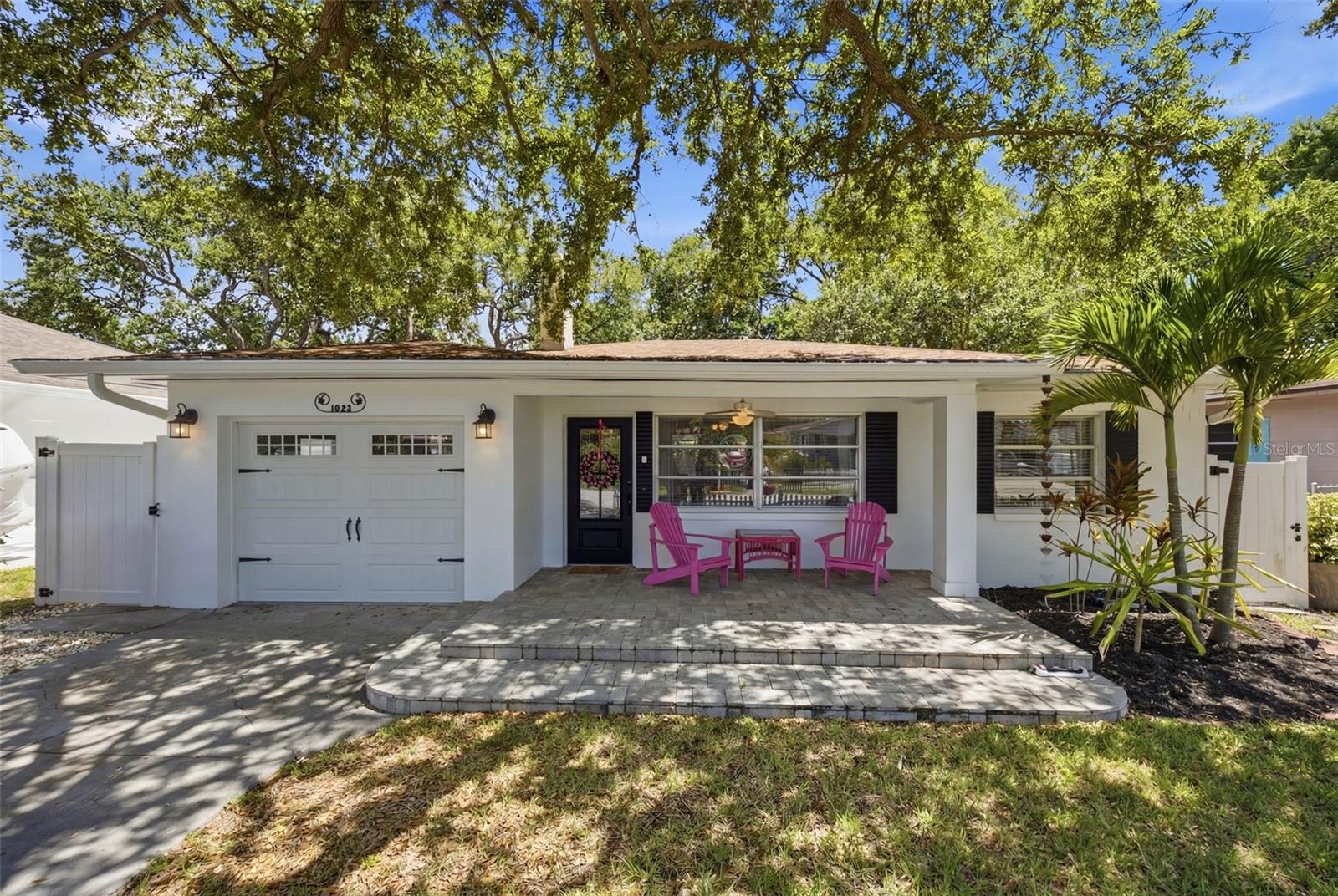 Coastal charm and exceptional curb appeal define this beautifully updated bungalow, perfectly positioned in one of Clearwater's most sought-after neighborhoods, just 5 houses down from the picturesque waterfront along Edgewater Drive. Enjoy breathtaking Gulf sunsets, peaceful waterfront strolls, and the relaxed Florida lifestyle that makes this location so special.
Situated on a fenced 50' x 125' lot with no HOA, this move-in-ready 2-bedroom, 2-bath home has been thoughtfully updated while preserving its timeless charm and character. From the adorable picket fence welcoming you home to the charming paver driveway, inviting front porch, and refreshed tropical landscaping, every detail creates a warm and inviting first impression. Inside, you'll find fresh interior paint, beautiful laminate wood-plank flooring, and a cozy living room centered around a wood-burning fireplace featuring custom hand-selected sea glass and a one-of-a-kind handcrafted mantle. The beautifully remodeled kitchen showcases quartz countertops, modern cabinetry, stainless steel appliances, and stylish finishes, while both bathrooms have been tastefully renovated, making this home truly move-in ready.

Step into your own private backyard oasis featuring a sparkling swimming pool, a cozy fire pit, and plenty of room to entertain family and friends or unwind in the privacy of your tropical retreat. Whether you're hosting weekend gatherings, enjoying your morning coffee poolside, or relaxing beneath the stars after a sunset stroll along Edgewater Drive, this backyard was designed for the very best of Florida outdoor living.

The location is truly exceptional. Just minutes from vibrant Downtown Dunedin, you'll enjoy award-winning restaurants, craft breweries, boutique shopping, the marina, and year-round festivals. Spend the day exploring the pristine beaches and nature trails of Honeymoon Island State Park, bike or walk nearly 50 miles along the Pinellas Trail, or take a short drive to the world-famous sands and crystal-clear waters of Clearwater Beach.

Whether you're searching for a primary residence, seasonal retreat, or investment opportunity, this exceptional home offers the perfect blend of timeless character, thoughtful updates, a private backyard oasis, and an unbeatable location where every sunset, every stroll, and every day captures the best of Florida coastal living.
