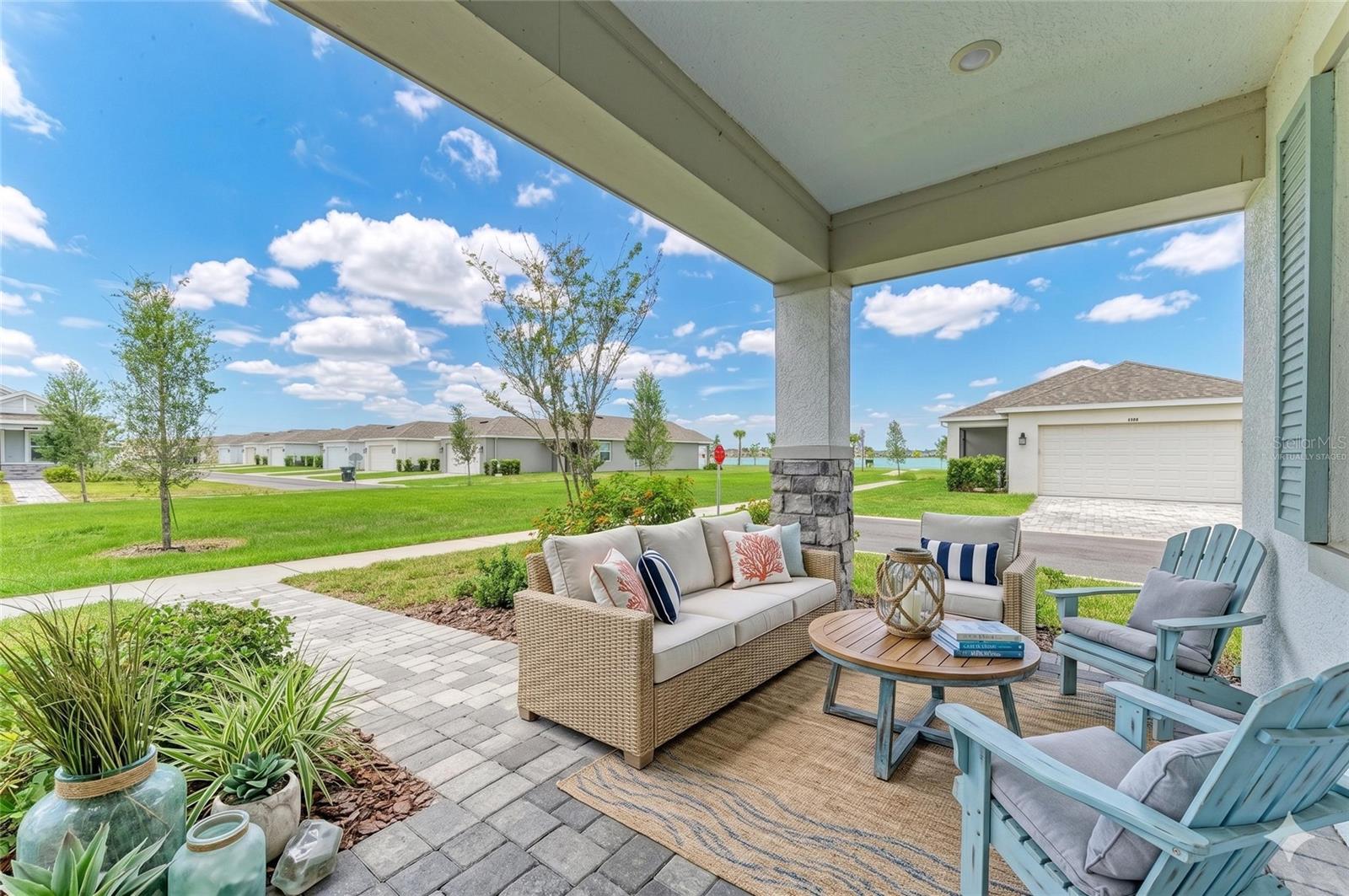 Virtually Staged. Walk, bike, paddle, play pickleball, dine, and enjoy waterfront living in Sarasota's highly desirable Waterside community. This beautifully designed 3-bedroom, 2-bath residence with a versatile flex room offers the perfect blend of comfort, style, and the active Florida lifestyle buyers are seeking.

Perfectly positioned to capture partial views of Kingfisher Lake, this home invites you to begin your mornings with coffee on the porch and end your evenings enjoying peaceful lake breezes. Residents enjoy access to a lakeside cabana and pool overlooking Kingfisher Lake, pickleball courts, dog park, playground, and the convenience of a private community dock where the water taxi can take you to Waterside Place for dining, shopping, farmers markets, live entertainment, and year-round events.

Inside, the thoughtfully designed open-concept floor plan offers approximately 1,743 (under air) square feet of living space featuring a spacious great room, a flexible bonus room ideal for a home office, fitness room, hobby space, or guest retreat, quartz countertops with matching quartz backsplash, stainless steel appliances, generous storage, and an inside laundry room. The primary suite provides a relaxing retreat, while premium Big Ass Haiku smart ceiling fans throughout the home add exceptional comfort and can be controlled by remote or smartphone app. Impact windows provide peace of mind, and the two-car garage offers ample space for vehicles and storage.

More than just a home, this is an opportunity to embrace the vibrant Waterside lifestyle in one of Sarasota's most desirable master-planned communities. Whether you're searching for a full-time residence, seasonal getaway, or investment property, this exceptional property places you at the center of everything that makes Waterside so special.