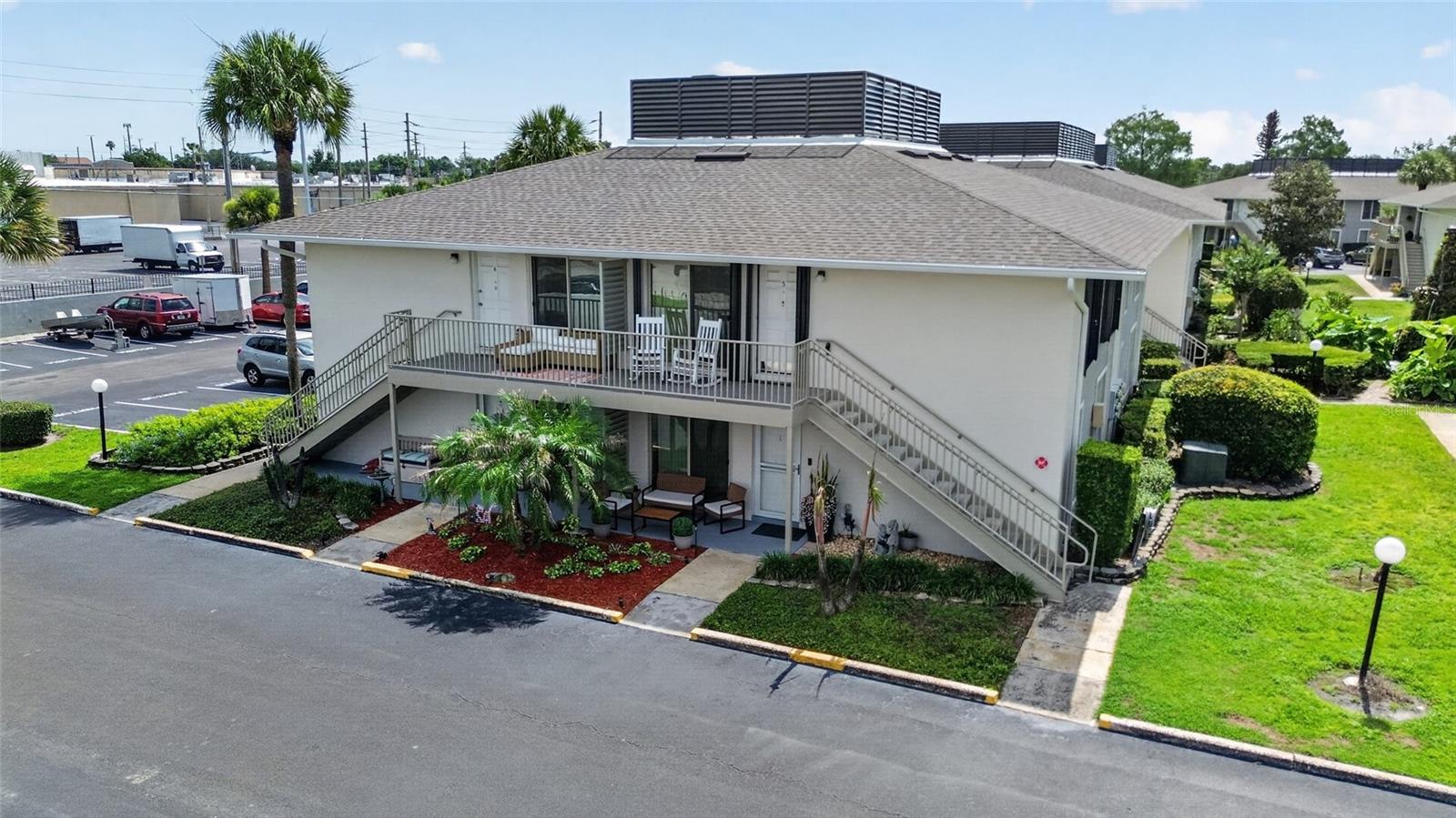 ALOHA and welcome to Mai Kai Condominiums, one of Conway's best-kept secrets! This charming 1-bedroom, 1-bath condo is located on the second floor.  The unit is filled with natural light, thanks to a newer sliding glass door to the balcony and large double-glazed windows throughout. Tucked away within a beautifully maintained gated community known for its tropical landscaping, water features, and resort-style atmosphere. The owner invested approximately $15,000 in 2025 improvements including: new water heater, updated electrical panel, hurricane shutters, and new blinds throughout.  Inside, you'll find a comfortable open floor plan where the kitchen features concrete countertops, and overlooks the living room and dining area with custom timber accent wall, creating an inviting space for everyday living and entertaining. The kitchen is both practical and stylish, equipped with a Samsung dishwasher, electric stovetop, fridge-freezer, microwave, double sinks with a pull-down faucet, and white subway tile backsplash. Sliding glass doors open to a private balcony, perfect for enjoying your morning coffee or relaxing at the end of the day. The spacious bedroom offers generous closet space, and additional storage is available in the hallway storage closet. Even better, a washer and dryer are conveniently located inside the unit.  Located just steps from the community pool and clubhouse, this condo offers easy access to Mai Kai's outstanding amenities including a tropical pool, tennis courts, clubhouse, scenic walking areas, relaxing pond waterfall feature, dog walk with lake views, assigned parking, guest parking, and on-site management. The HOA provides exceptional value by covering Spectrum cable with DVR, high-speed internet, water, trash, pest control, exterior insurance, gated entry, and grounds maintenance.  Recent community upgrades to Mai Kai include new windows, siding, soffits, roofs, balconies, and resurfaced parking lots.  One of the community's most popular features is the private gate providing direct access to Publix, restaurants, a gym, pharmacy, hardware store, and other shopping right next door. A bus stop is conveniently located in front of the community, and you're only minutes from Downtown Orlando, SoDo, Orlando International Airport, Lake Conway, Barber Park, and the Hourglass District's popular restaurants, coffee shops, breweries, and local markets. If you're looking for affordable, low-maintenance living in a prime Conway location, this Mai Kai condo is a wonderful place to call home or use on vacations.