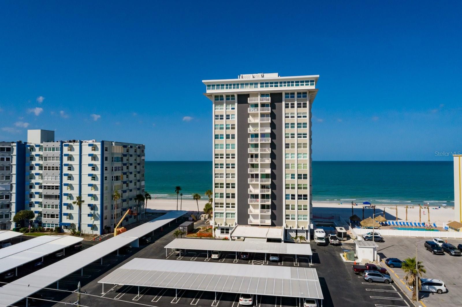 2 bedrooms & 2 full baths completely renovated condo located in The Club Redington right on the beach in Redington Shores. This beautiful condo features wood cabinetry with granite tops in kitchen & baths.  Large kitchen with breakfast bar & island.  Built-ins provide lots of storage.  Spacious living/dining room area is perfect for entertaining.  Sit on the side balcony enjoying a cool drink with lovely views of the beach & sunsets,  Primary becroom with walk-in closet & ensuite  bath.  Primary bath features a large shower with a built-in bench.  2nd balcony off primary bedroom.  Guest bedroom with guest bath right across the hall.  Hurricane Shutters 10/2023.  During both recent hurricanes this unit did not take on any water. This complex is going through renovations to get things back in excellent condition regarding Hurricane Helene.   In addition to a Secured building entry there are also lots of amenities.  Assigned covered parking, plenty of guest parking, full time onsite maintenance manager, outdoor BBQ area, 2 elevators, clubhouse w/kitchenette & billiards table, heated pool, renovated restrooms, & a soft water system for the entire building.   Located close to shopping & great restaurants.   A short drive to Tampa with thier performing arts, sports venues & chamoionship teams along with Tampa International Airport.  Also short drive to award wiining Clearwater Beach & downtown St Pete for lots of entertainment options.    Call for your private tour & Start Living the Florida Beach Lifestyle today!