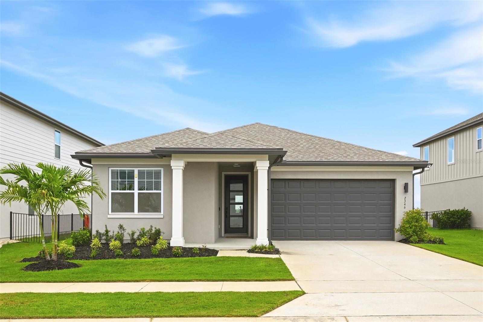 One-of-a-kind in popular Villages Hills of Minneola, this beautiful home is on an oversized lot with views! Enter inside and be ready to enjoy all the best of living life in a well-appointed home with upscale finishes. From the front entry door with attractive glass panes to floors with stone-polymer flooring, which provides a high level of beauty and impact resistance. Ten-foot ceilings and doors, double custom French doors and a tray ceiling present all of the comforts. The kitchen includes quartz counters, a huge island with bar seating and an oversized stainless steel sink. Samsung stainless steel appliances include a refrigerator, an oversized five-burner range top and oven, a dishwasher and a microwave. There is also a large walk-in pantry. Split bedroom plan with views from the primary bedroom. The primary bath is large with quartz counters and double sinks. There is also a spacious walk-in closet and upper shelving. There is a tub in the hall bath. The charming porch has a phantom electric screen. Energy-efficient double-paned windows, insulation in the attic, a two-car garage with an automatic opener and fiber optics in the community. There is a K-8 public school, grocery stores, shopping, a new Crooked Can, all within the immediate area and a new hospital and Lake Ridge Winery. Don't miss out.