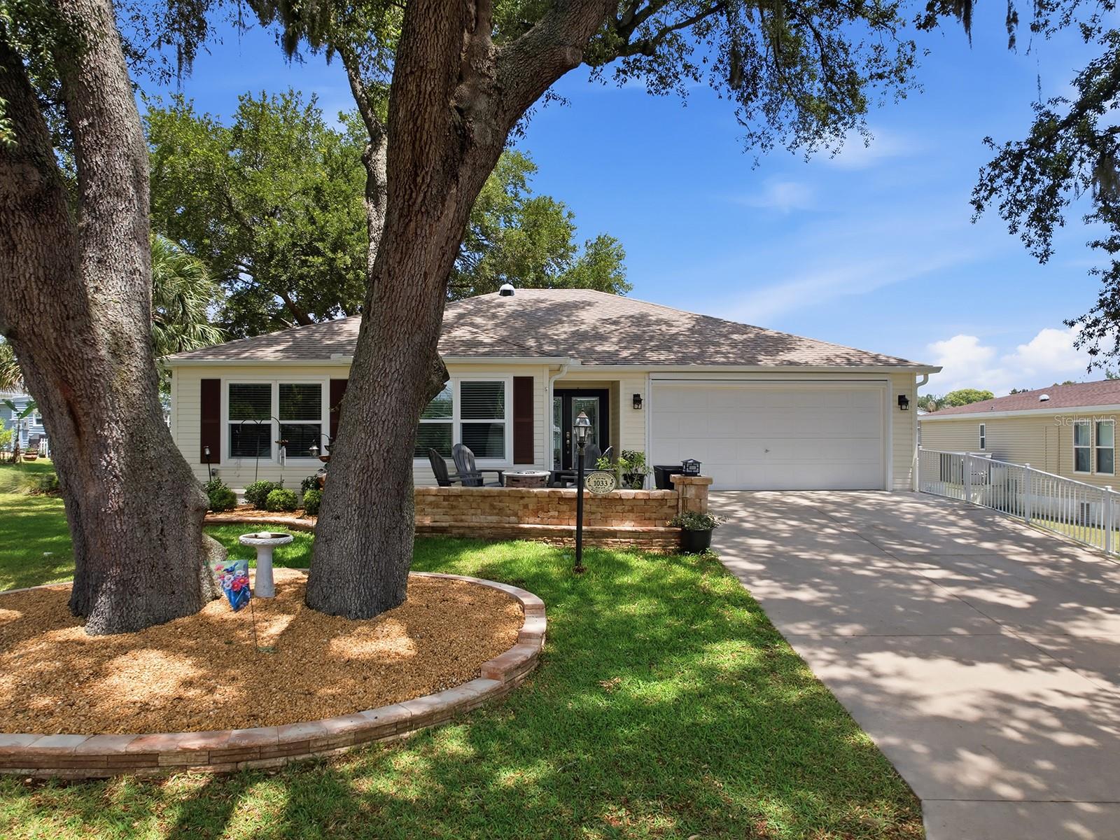 NO BOND on this beautifully updated and enhanced “stick-built” ANCHOR model located in the historic Village of Orange Blossom Hills! Situated on an oversized lot, this charming home welcomes you with majestic live oaks providing wonderful shade over the front paver patio and entryway.
Inside, you’ll find Luxury Vinyl Plank flooring throughout the main living areas, with tile flooring in the bathrooms and the enclosed lanai. The spacious enclosed lanai is under heat and AC, creating the perfect year-round living space. Additional interior upgrades include canned lighting, a solar tube in the living room for added natural light, Ceiling Fans, and a beautiful front door with leaded glass and a matching sidelight panel.
The kitchen and bathrooms feature elegant quartz countertops along with updated sinks and hardware for a modern touch. There is also a new garbage disposal.  The primary suite offers a large walk-in closet and an en-suite bath with dual sinks and a walk-in shower.
Outdoor living is equally inviting with paver patios in both the front entry area and rear patio space. Major exterior improvements include new gutters in 2024 and gutter guards added in 2025.
Conveniently located just 5 minutes from the golf cart bridge to the Spanish Springs Town Square corridor, you’ll enjoy easy access to restaurants, shopping, entertainment, and UF Health Spanish Plaines Hospital. This move-in ready home is a must-see—schedule your showing today!